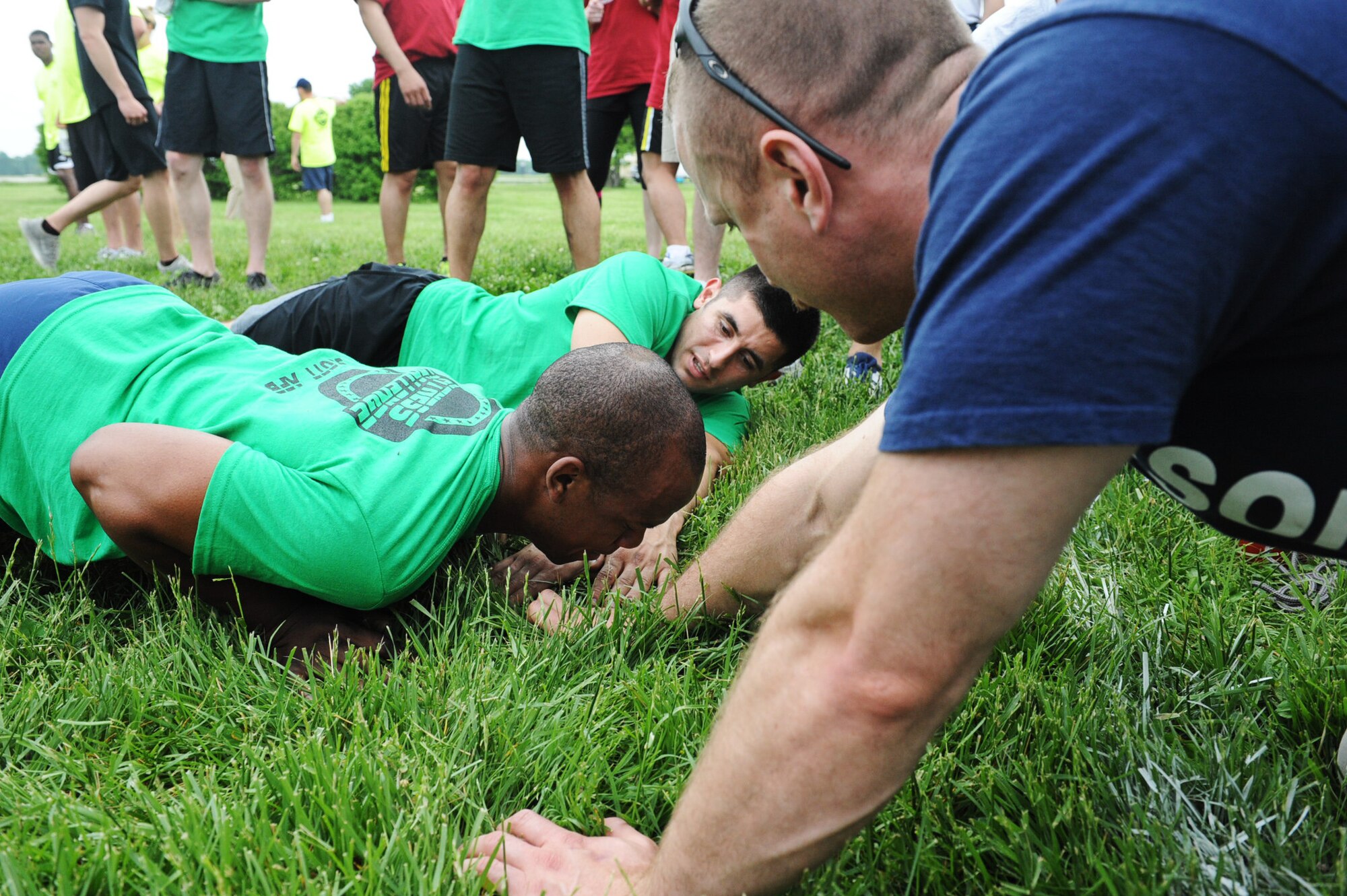 Members of the 375th Civil Engineer Squadron encourage their teammate to hold their position in the frozen push-up portion of the 2013 Unit Fitness Challenge at the Airman Leadership School field. The 375th CES ended up placing first, while the 15th Operational Weather Squadron earned second, the 635th Supply Chain Operations Group earned third, the 375th Security Forces Squadron earned fourth and 375th Logistics Readiness Squadron earned fifth. (U.S. Air Force photo/Senior Airman Jake Eckhardt)