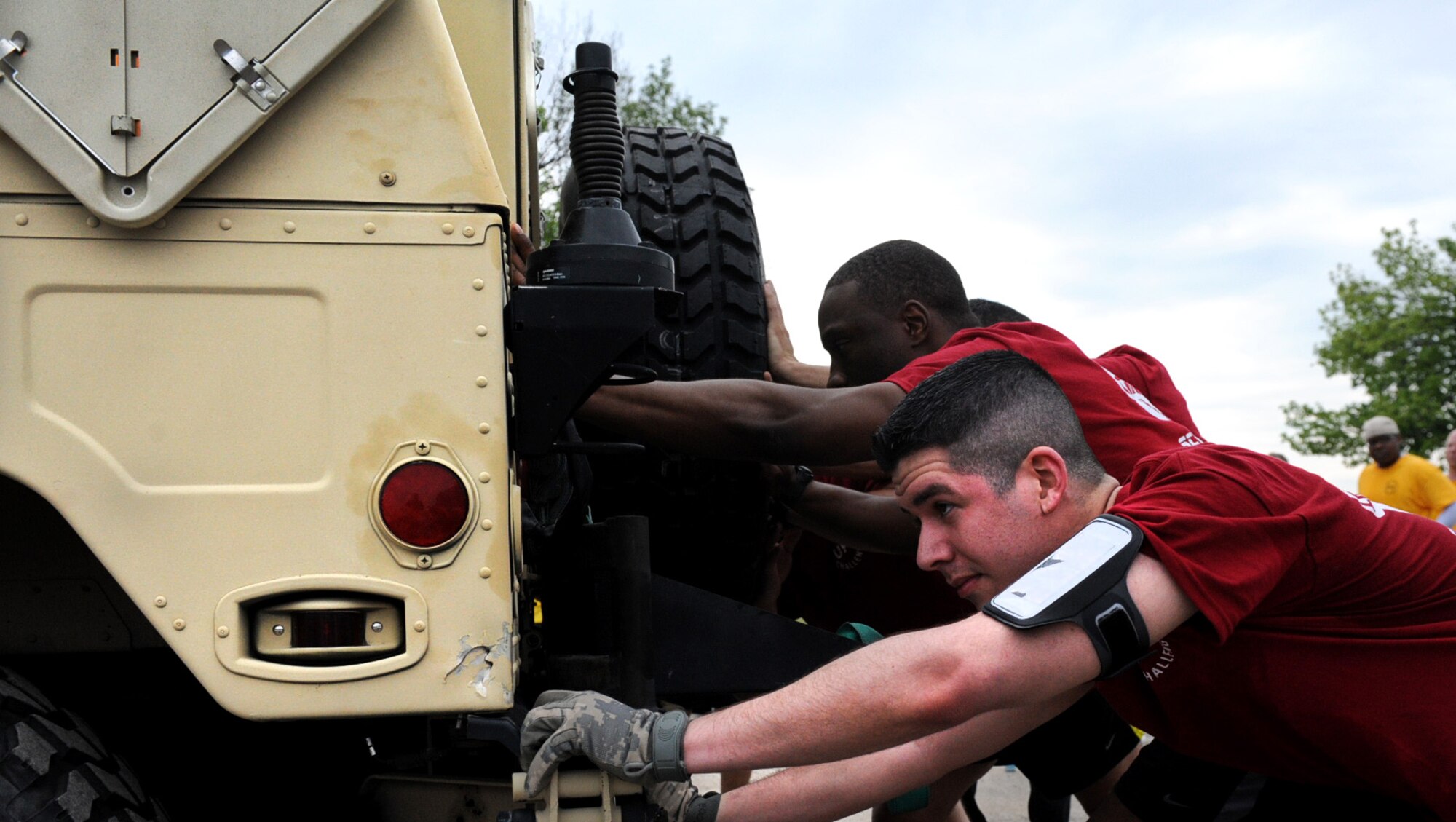 Members of the 375th Communication Support Squadron team got into position to push a Humvee at the Airman Leadership School May 17. There were five events in the 2013 Unit Fitness Challenge; a 5K, 10K, Humvee push, tire flip and frozen push-ups. (U.S Air Force photo/Senior Airman Jake Eckhardt)