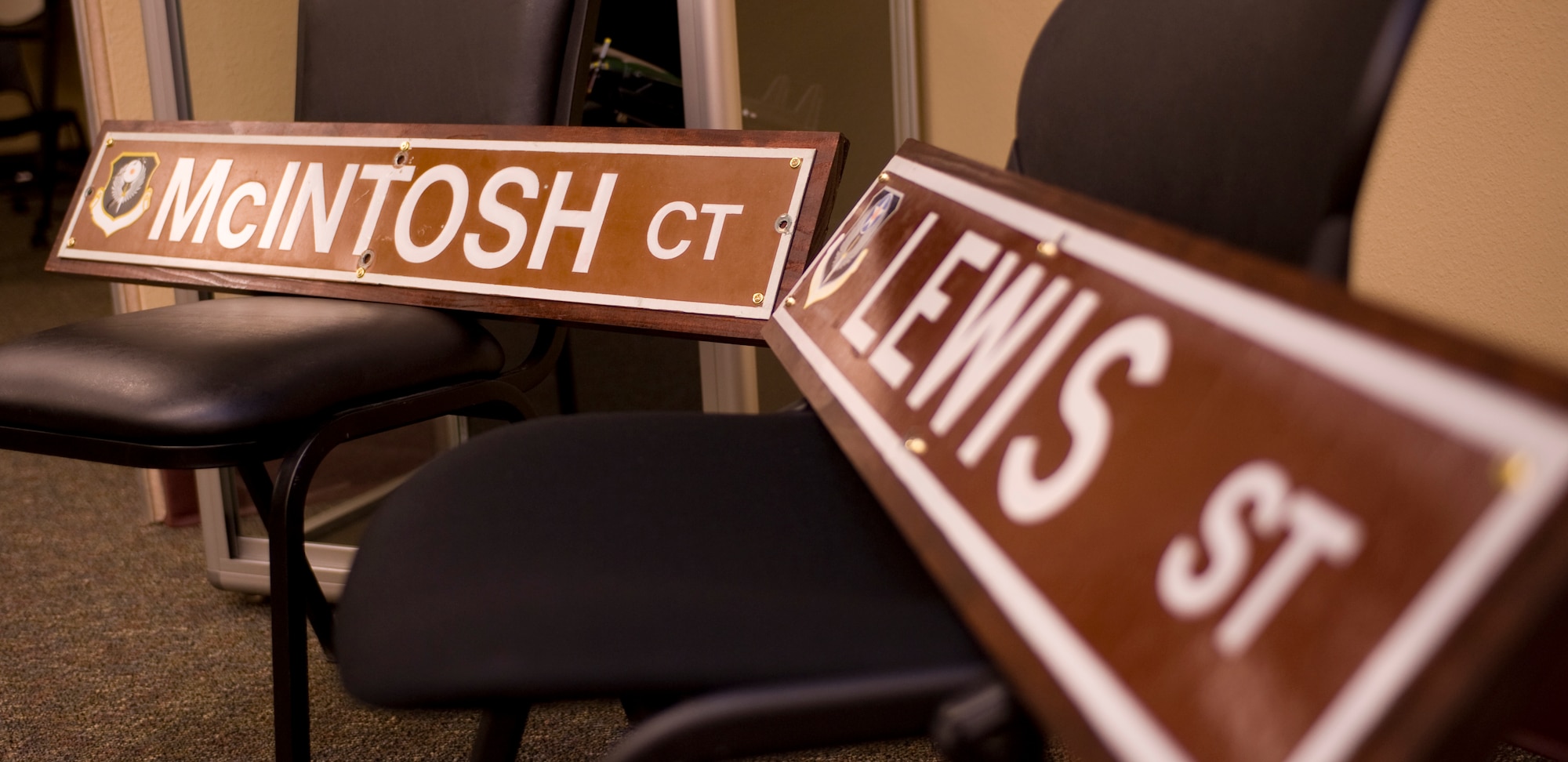 Two signs presented to the Command Pride Airman Center are temporarily displayed at Hurlburt Field, Fla., May 17, 2013.  The signs are named after Maj. Harold L. Lewis, pilot and aircraft commander, and Maj. Lyn D. McIntosh, co-pilot, as a reminder to new Airmen of lessons learned in Desert One during Operation Eagle Claw.  (U.S. Air Force photo by Airman 1st Class Benjamin Kim) 