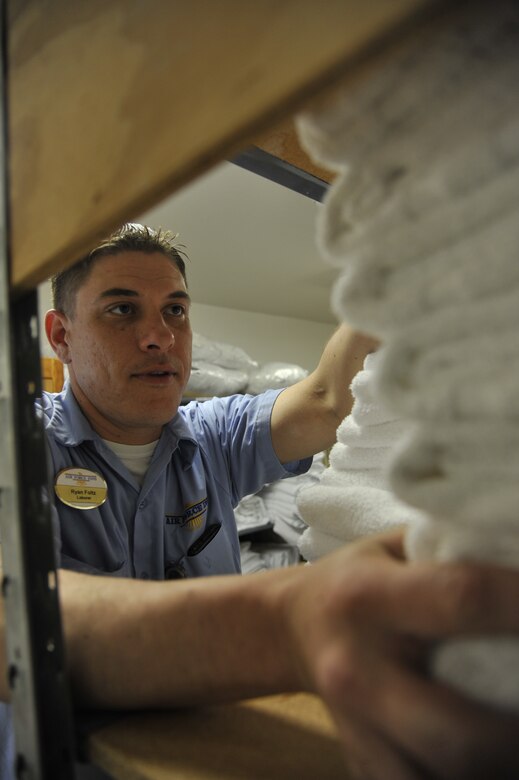 Ryan Foltzs, 509th Force Support Squadron maintenance crew member, restocks towels and linen at the Whiteman Inn on Whiteman Air Force Base, Mo., May 7, 2013. When all used linen is collected from the hotel, the maintenance crew will count and give them to the contractors to clean. Once the linen is cleaned, the maintenance crew will receive them to do linen exchange. (U.S. Air Force photo by Airman 1st Class Keenan Berry/Released)
