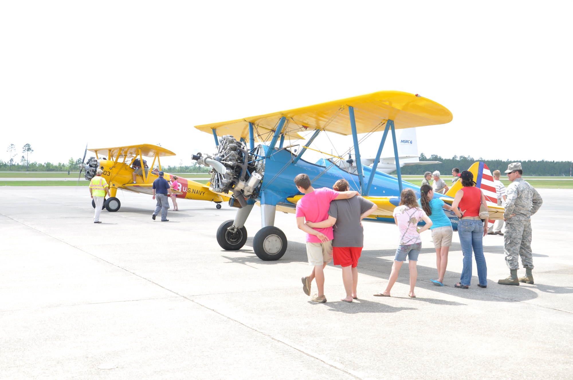 Pilots and their families admire general aviation aircraft that are lined up at Stennis International Airport during Keesler’s Military and Civilian Joint Safety Day May 18, 2013 at Stennis International Airport in Kiln, Miss. A product of the Mid-Air Collision Avoidance program, the event was open to all area pilots to increase dialogue between the military and civilian aviation communities. (U.S. Air Force photo by Airman 1st Class Stephan Coleman)