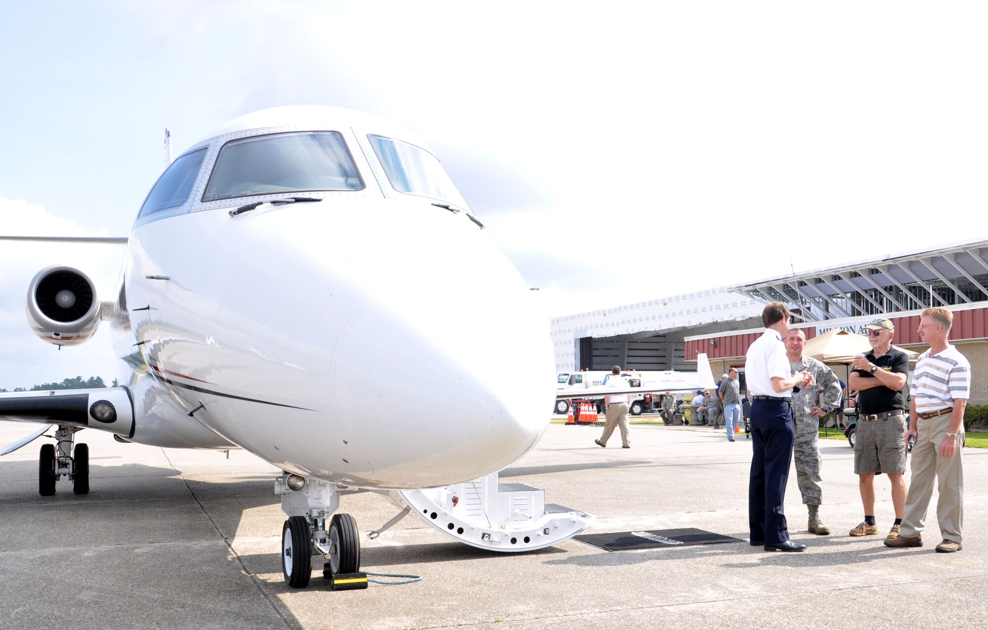 Dave Burghard, pilot; Maj. Troy Kirkbride, 81st Operations Support Squadron commander; Burl Nelson, president of the Experimental Aviation Association Chapter 479 and Dudley Cruse, 81st Training Wing chief of flight safety, discuss the nearby Gulfstream G200 aircraft during Joint Safety Day May 18, 2013 at Stennis International Airport in Kiln, Miss. A product of the Mid-Air Collision Avoidance program, the event was open to all area pilots to increase dialogue between the military and civilian aviation communities. (U.S. Air Force photo by Airman 1st Class Stephan Coleman)