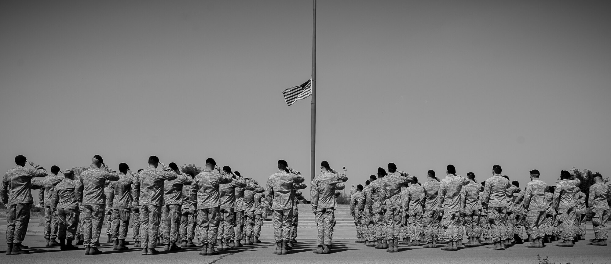 U.S. Air Force Airmen from the 7th Security Forces Squadron (SFS) salute the American flag during a retreat ceremony May 16, 2013, at Dyess Air Force Base, Texas. In 1962, President John F. Kennedy proclaimed May 15 as National Peace Officers Memorial Day and the calendar week in which May 15 falls, as National Police Week. The week pays special recognition to law enforcement officers who lost their lives in the line of duty for the safety and protection of others. The 7th SFS held a jail-and-bail fundraiser, vehicle display, weapons display and bike rodeo throughout the week. (U.S. Air Force photo by Senior Airman Jonathan Stefanko/Released)