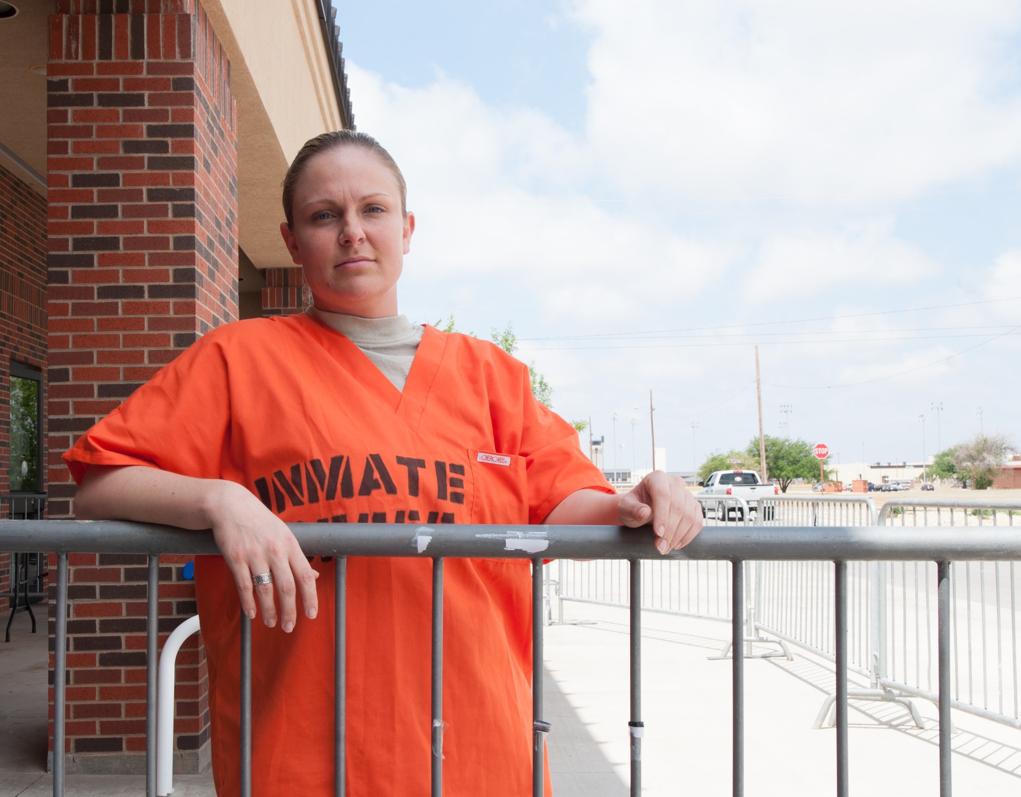 U.S. Air Force Staff Sgt. Elizabeth Mann, 7th Bomb Wing judge advocate, waits in a make-shift prison during a jail-and-bail fundraiser May 16, 2013, at Dyess Air Force Base, Texas. The fundraiser was held during National Police Week, proclaimed by President John F. Kennedy in 1962, to honor those who have made the ultimate sacrifice. (U.S. Air Force photo by Senior Airman Jonathan Stefanko/Released)