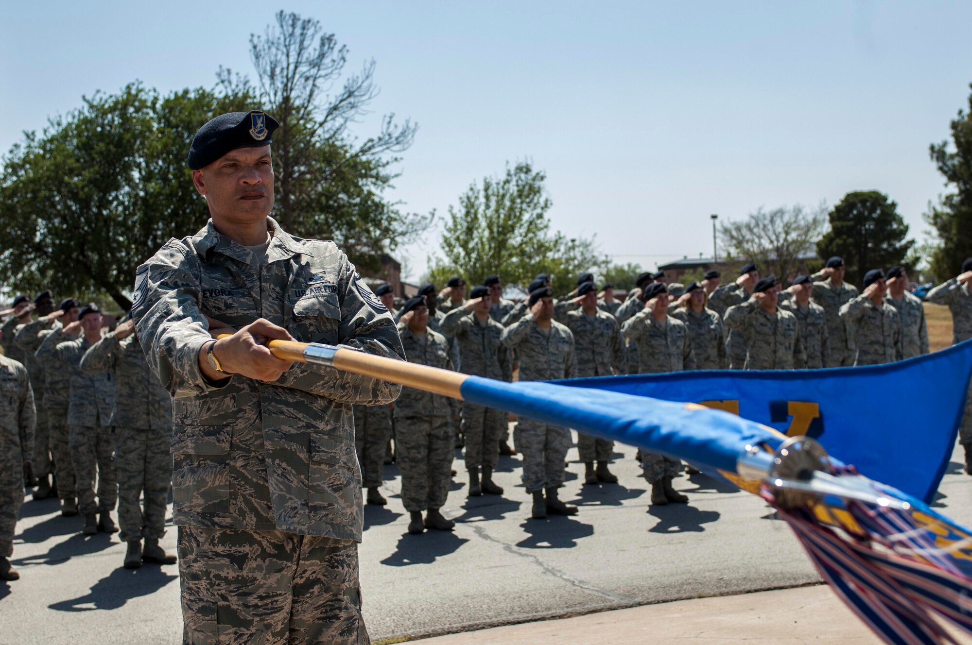 U.S. Air Force Master Sgt. Shawn Evora, 7th Security Forces Squadron (SFS), presents the 7th Mission Support Group guidon during a retreat ceremony May 16, 2013, at Dyess Air Force Base, Texas. In 1962, President John F. Kennedy proclaimed May 15 as National Peace Officers Memorial Day and the calendar week in which May 15 falls, as National Police Week. The week pays special recognition to law enforcement officers who lost their lives in the line of duty for the safety and protection of others. The 7th SFS held a jail-and-bail fundraiser, vehicle display, weapons display and bike rodeo throughout the week. (U.S. Air Force photo by Airman 1st Class Kylsee Wisseman/Released)