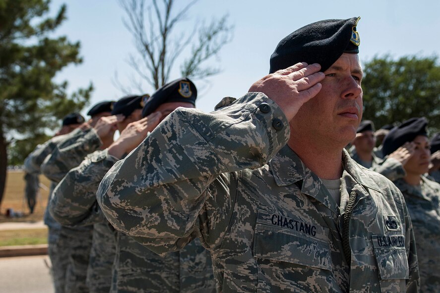 U.S. Air Force Airmen from the 7th Security Forces Squadron (SFS) salute the American flag during a retreat ceremony May 16, 2013, at Dyess Air Force Base, Texas. In 1962, President John F. Kennedy proclaimed May 15 as National Peace Officers Memorial Day and the calendar week in which May 15 falls, as National Police Week. The week pays special recognition to law enforcement officers who lost their lives in the line of duty for the safety and protection of others. The 7th SFS held a jail-and-bail fundraiser, vehicle display, weapons display and bike rodeo throughout the week. (U.S. Air Force photo by Airman 1st Class Kylsee Wisseman/Released)