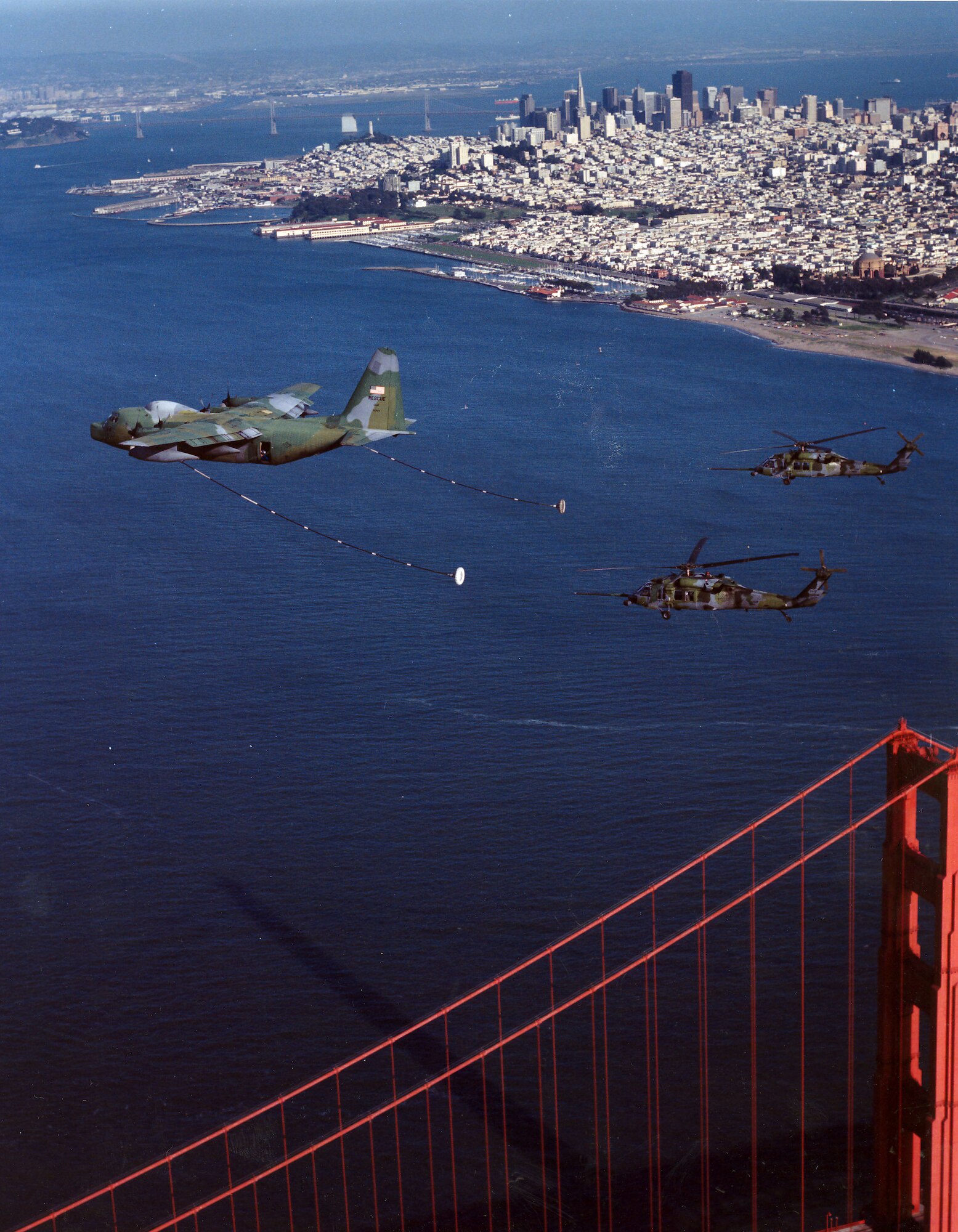 Aircrafts from the 129th Rescue Wing fly in formation over San Francisco, California, circa 2000.  The mission of the 129th is to train and be prepared to perform its wartime mission of combat search and rescue anywhere in the world. Its personnel and aircraft locate and recover aircrew and non-aircrew personnel from both enemy-held and friendly territory and seas. In addition, the 129th provides manpower, materiel and equipment to conduct peacetime search and rescue operations in the Pacific Ocean and off the coast of California.  (U.S. Air Force photo by Master Sgt. Rich Loomis)
