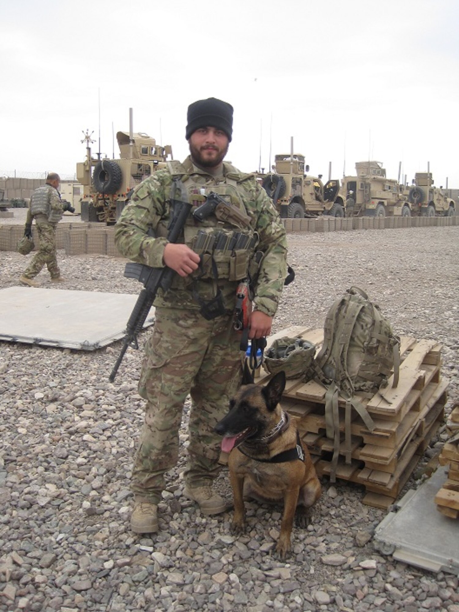 Staff Sgt. Zachary Cahall, 436th Security Forces Squadron dog handler, poses with his dog “Iggy” Dec. 5, 2012, at Shindad Air Base in Western Afghanistan. Cahall was wounded during an incident near his deployed location Dec. 28, 2012. (Courtesy photo)