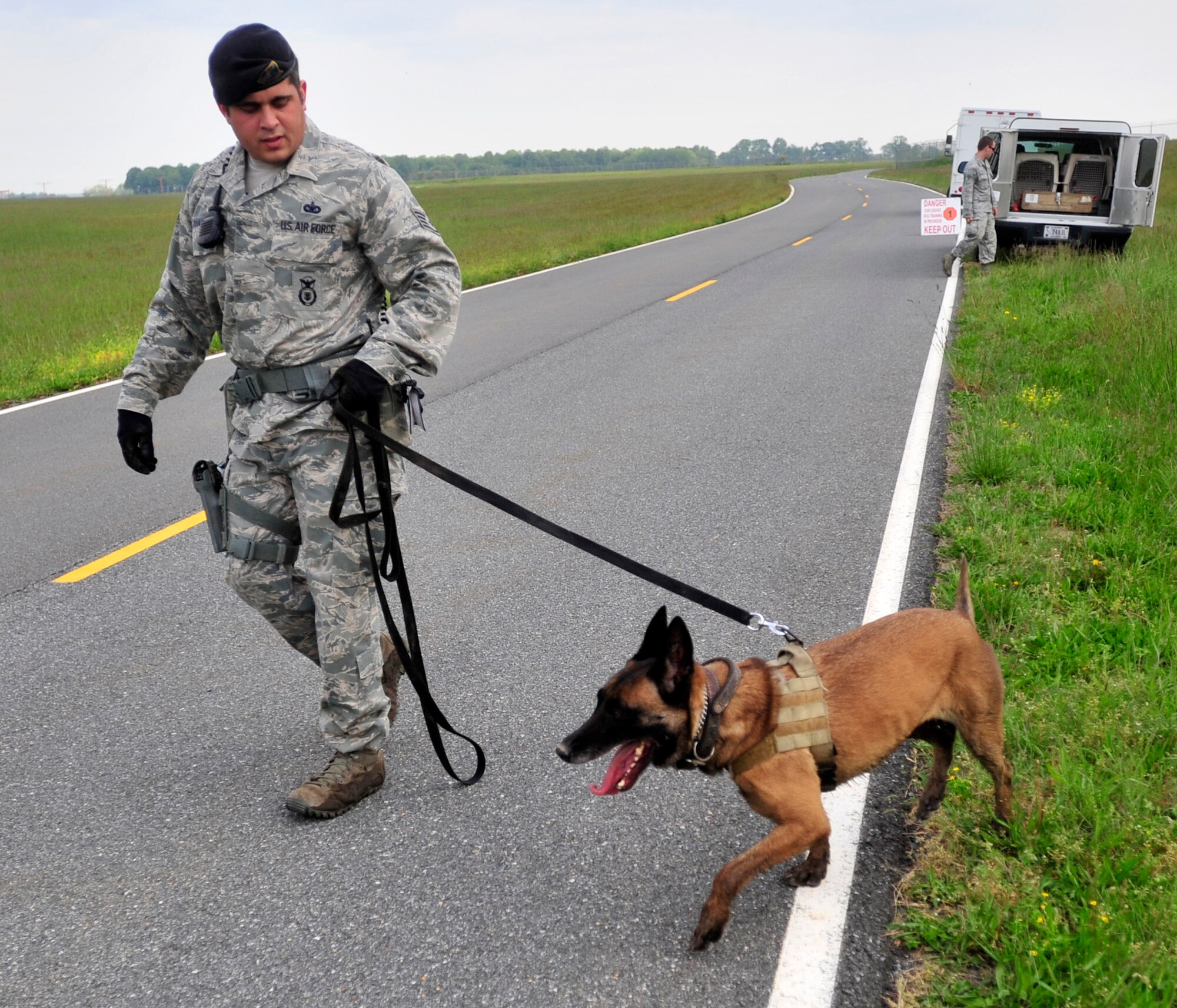 Staff Sgt. Zachary Cahall, 436th Security Forces Squadron dog handler, walks his dog “Iggy” to their vehicle following training May 16, 2013, at Dover Air Force Base, Del. Cahall suffered wounds during his deployment to Shindand Air Base in Western Afghanistan in Dec. 2012. (U.S. Air Force photo/Tech. Sgt. Chuck Walker)