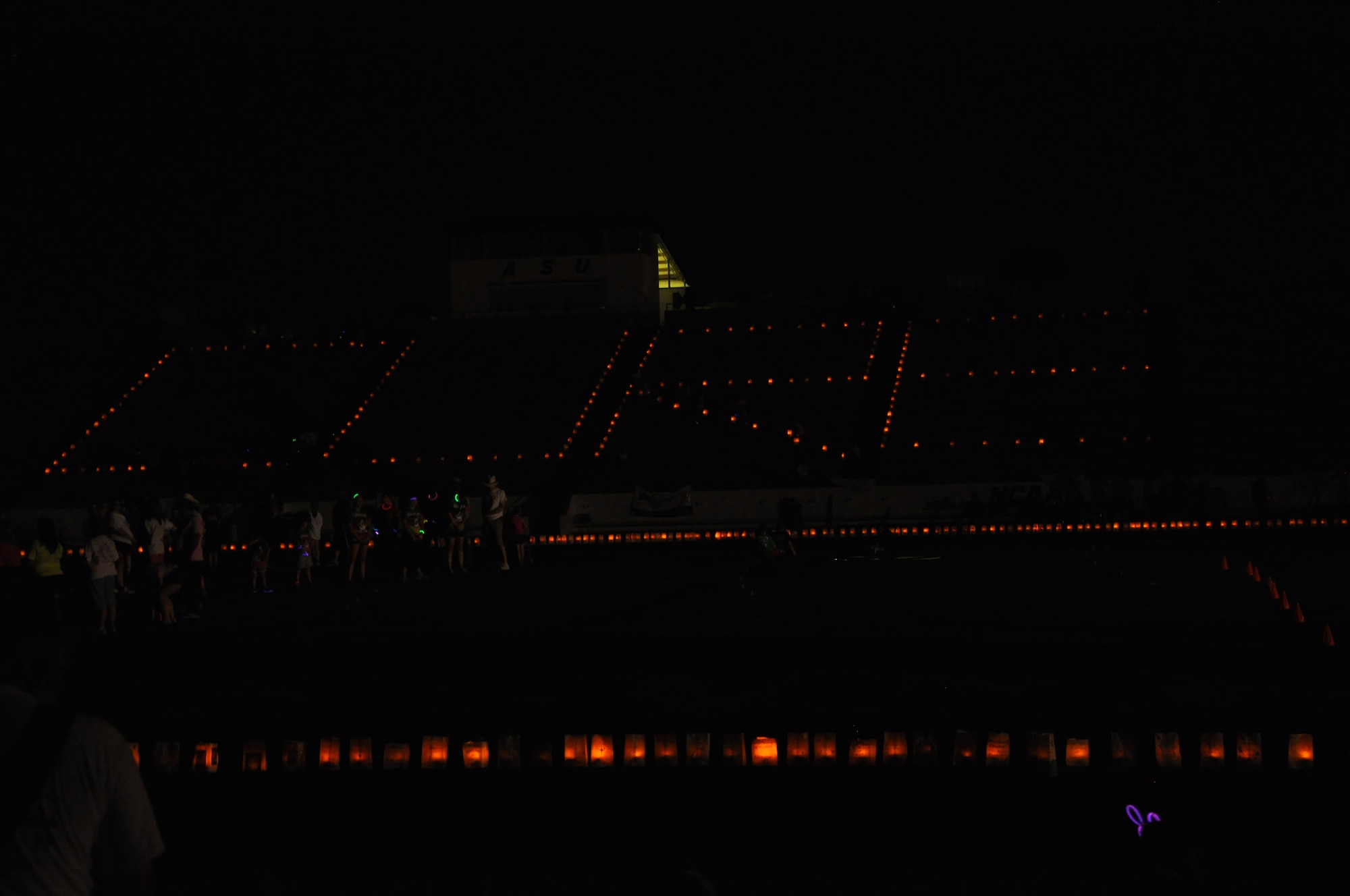 SAN ANGLEO, Texas – Volunteers light miniature plastic candles in paper bags, during the luminaria ceremony for the Relay for Life event at the Angelo State University track and field May 17. At the beginning of the ceremony, the word hope was spelled out in the lights. (U.S. Air Force photo/ Airman 1st Class Joshua Edwards)