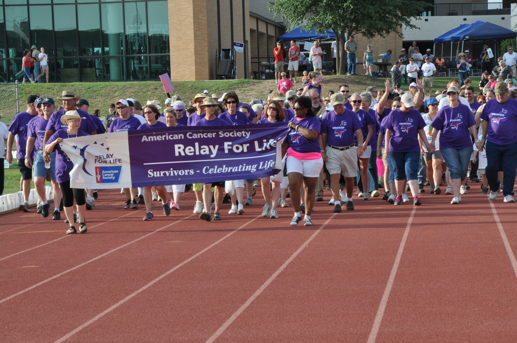 SAN ANGELO, Texas – Cancer survivors walk the first lap at the Relay for Life event at Angelo State University track and field May 17. The relay raised more than $238,000 to help fight cancer. (U.S. Air Force photo/ Airman 1st Class Joshua Edwards)