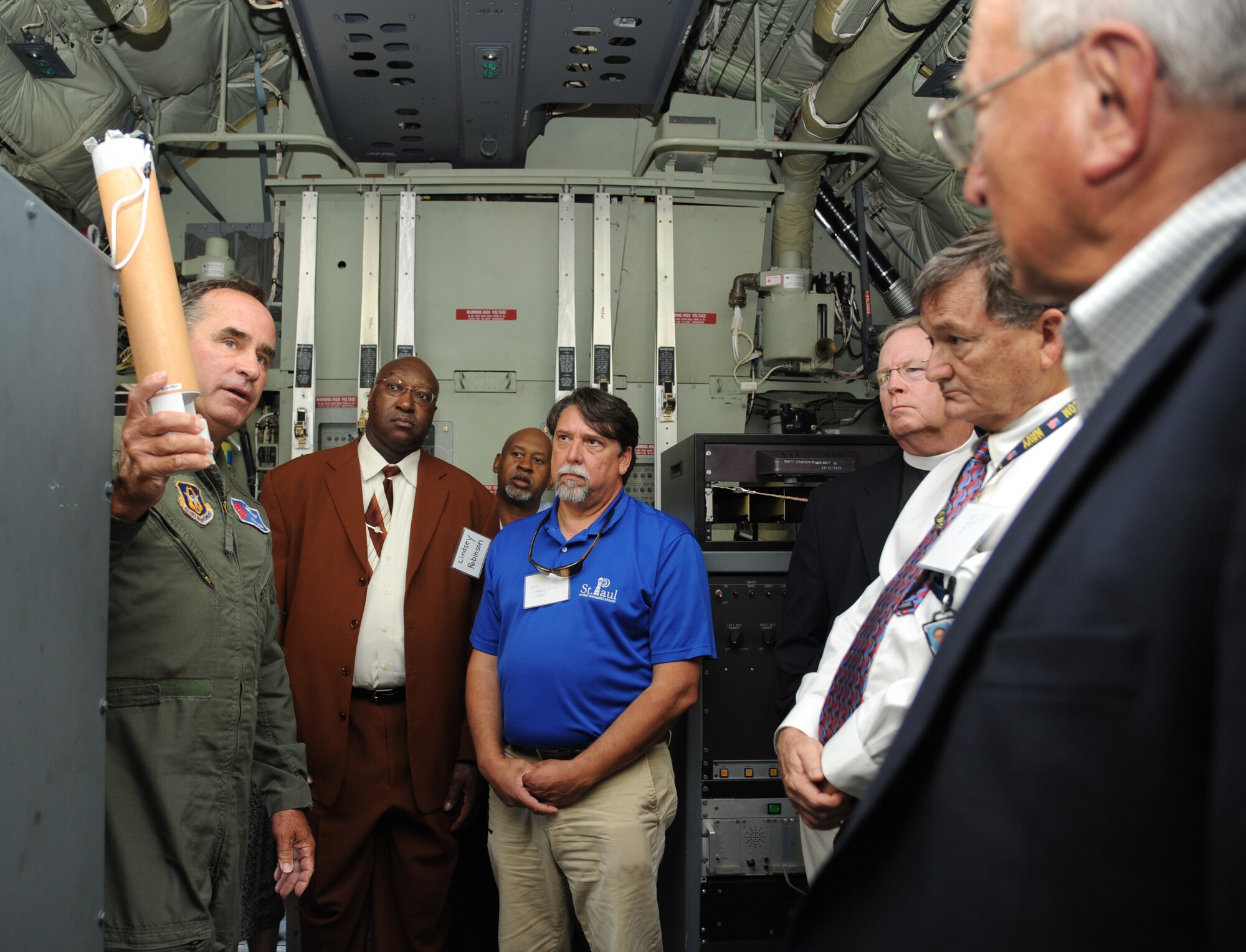 Lt. Col. Rich Harter, 53rd Weather Reconnaissance Squadron, explains to local clergymen how a dropsonde is used to measure tropical storm conditions aboard a C-130J aircraft during a briefing about the Hurricane Hunters’ flying mission, May 20, 2013, at Keesler Air Force Base, Miss.  Throughout the one-day visit in celebration of clergy day, local clergymen and clergywomen also received briefings about the 81st Medical Group and the 81st Training Wing.  (U.S. Air Force photo by Kemberly Groue)