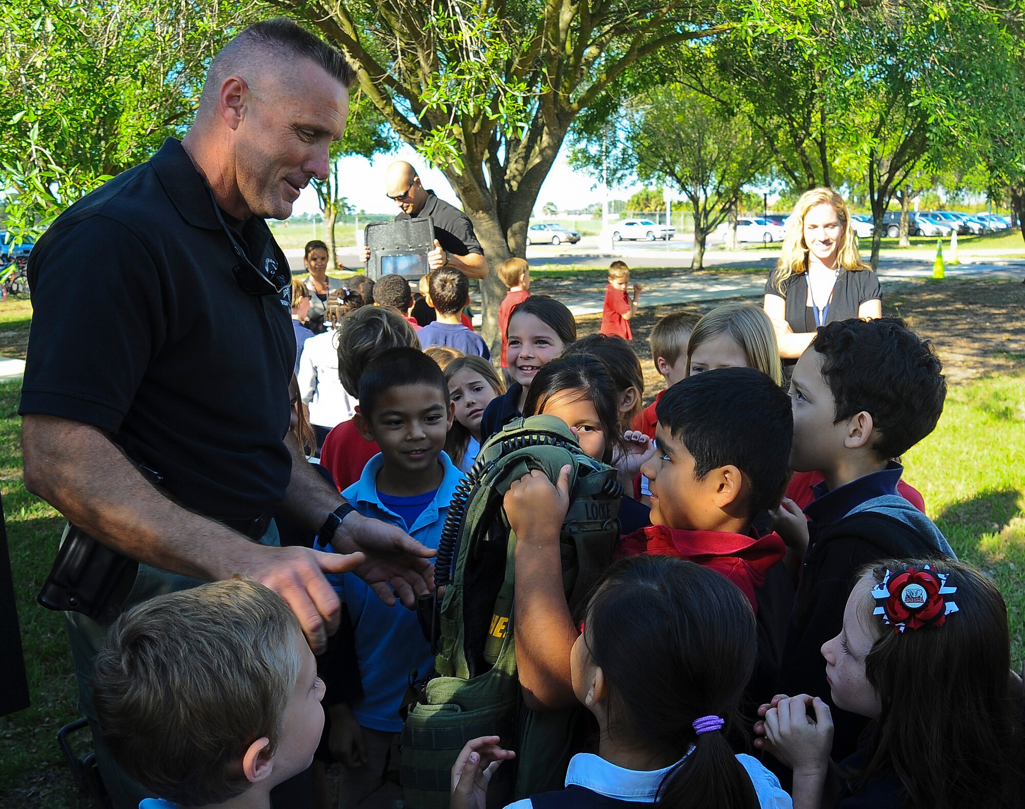 Shannon Locke, Hillsborough County Sherriff’s Office detective, shows-off special tactics equipment to children at Tinker Elementary School on May 15, 2013 at MacDill Air Force Base, Fla. Each year, as part of National Police Officer Week, members from the 6th Security Forces Squadron and local police departments put on a show-and-tell depicting the different aspects involved in public safety. (U.S. Air Force photo by Staff Sgt. Brandon Shapiro/ Released)