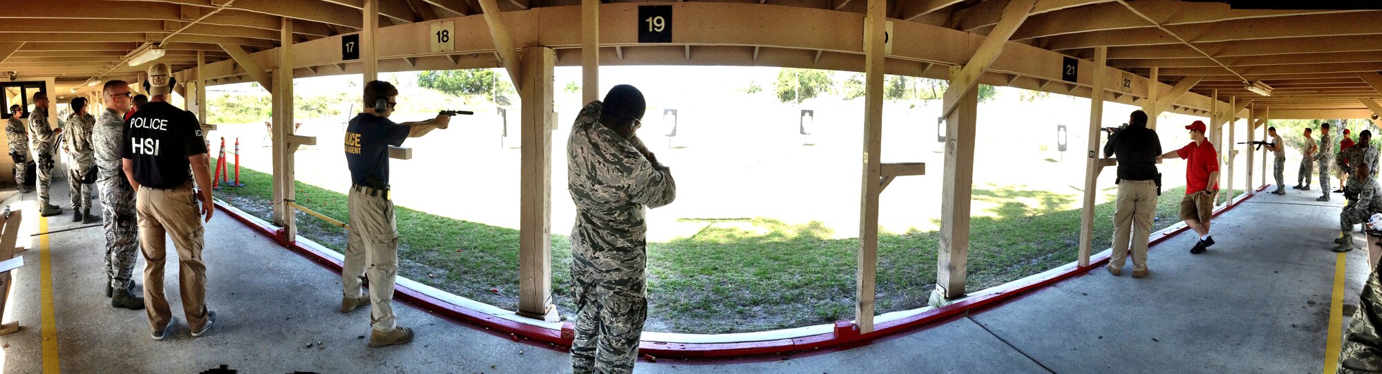 Members from the 6th Security Forces Squadron and local law enforcement agencies take to range at MacDill Air Force Base, Fla on May 16, 2013. The event included a team shooting competition, open range practice and a grill-out to celebrate National Police Officer Week. (U.S. Air Force photo by Staff Sgt. Brandon Shapiro/ Released)