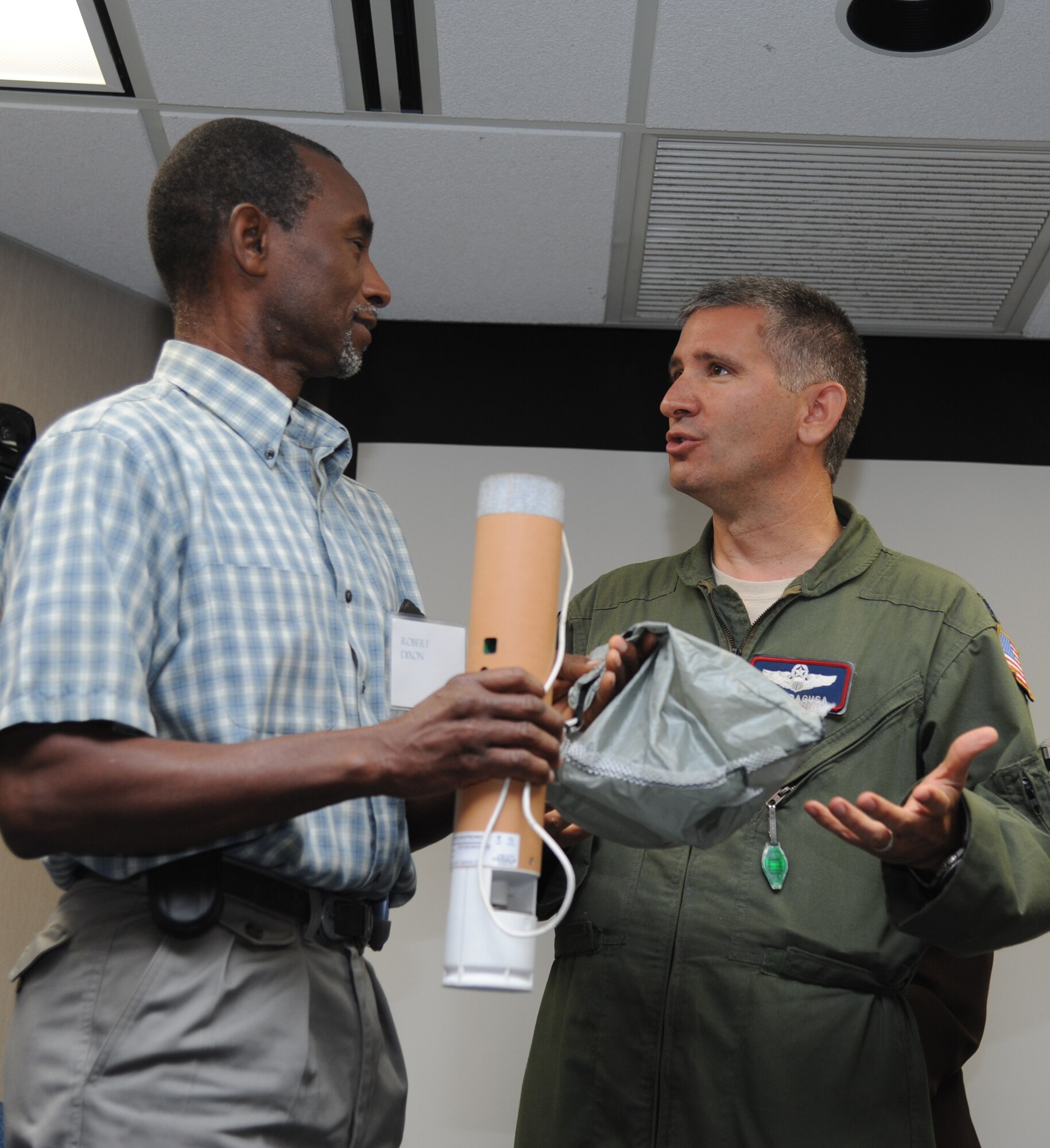 Robert Dixon, local clergyman, learns how a dropsonde is used to measure tropical storm conditions from Lt. Col. Jeff Ragusa, 53rd Weather Reconnaissance Squadron, during a briefing about the Hurricane Hunters’ flying mission, May 20, 2013, at Keesler Air Force Base, Miss.  Throughout the one-day visit in celebration of clergy day, local clergymen and clergywomen also received briefings about the 81st Medical Group and the 81st Training Wing.  (U.S. Air Force photo by Kemberly Groue)