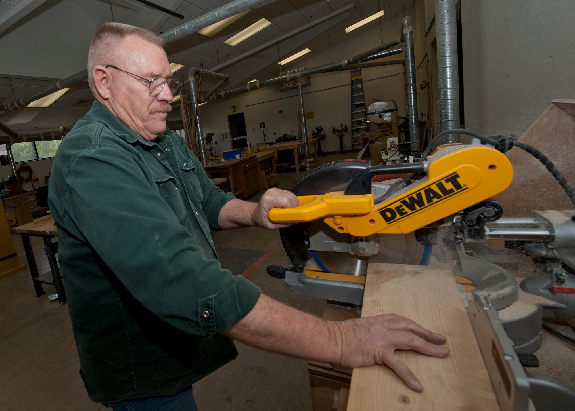 Joe Brinegar, 49th Force Support Squadron wood shop supervisor, uses a saw to cut a piece of wood inside the Arts and Crafts Center at Holloman Air Force Base, N.M., May 14. The wood shop offers Airmen the opportunity to utilize top-of-the-line wood working equipment to complete personal projects or satisfy hobbies. The wood shop is open Tuesdays, Thursdays and Saturdays from 4 p.m. to 7 p.m. (U.S. Air Force photo by Airman 1st Class Daniel E. Liddicoet/Released)
