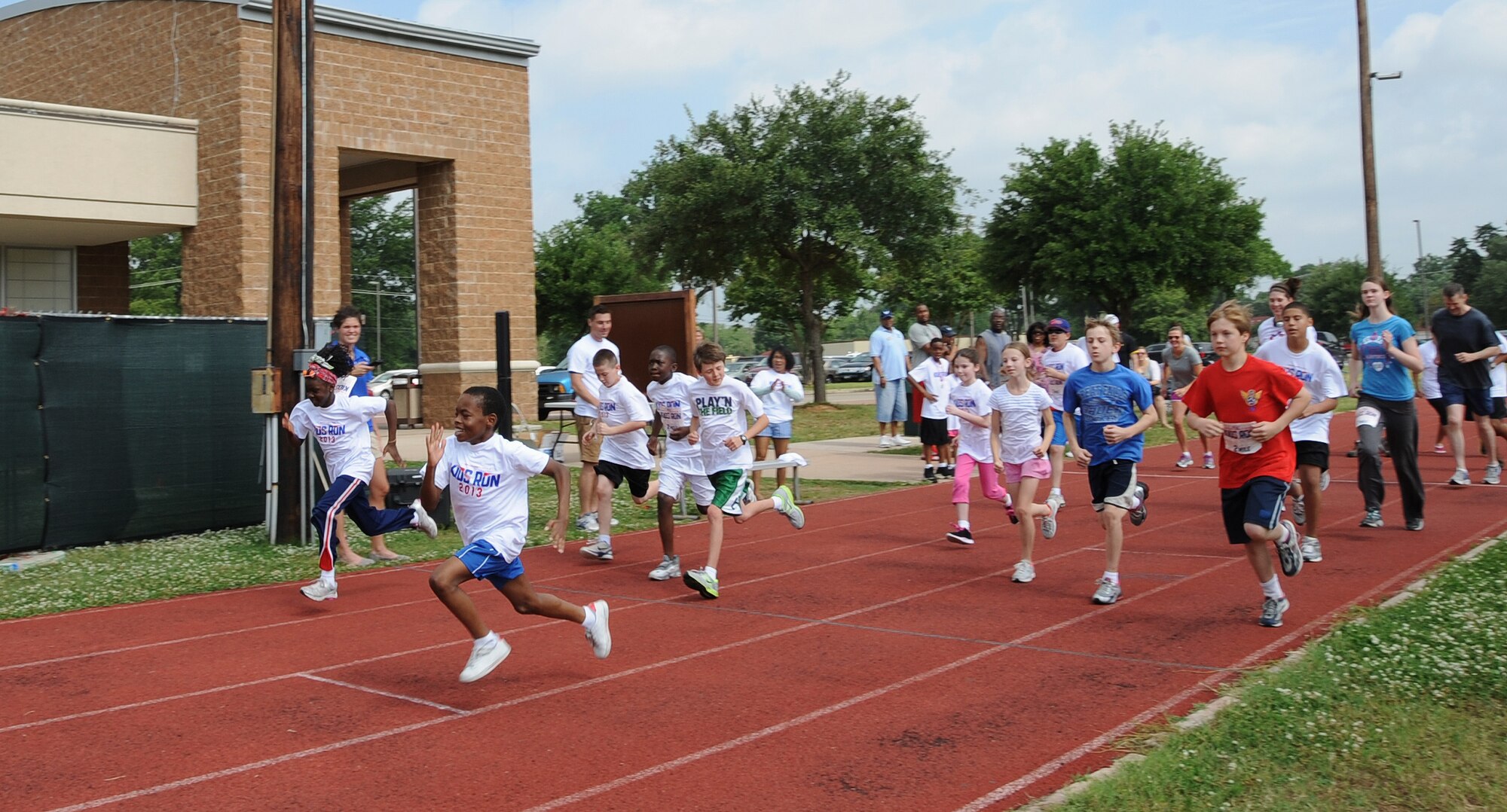 Barksdale children take off during the two-mile Kids Run on Barksdale Air Force Base, La., May 18, 2013. The Kids Run featured three different runs, a half-mile run for 5 and 6 year olds, a one-mile run for 7 and 8 year olds and a two-mile run for 9 to 13 year olds. (U.S. Air Force photo/Airman 1st Class Benjamin Gonsier)