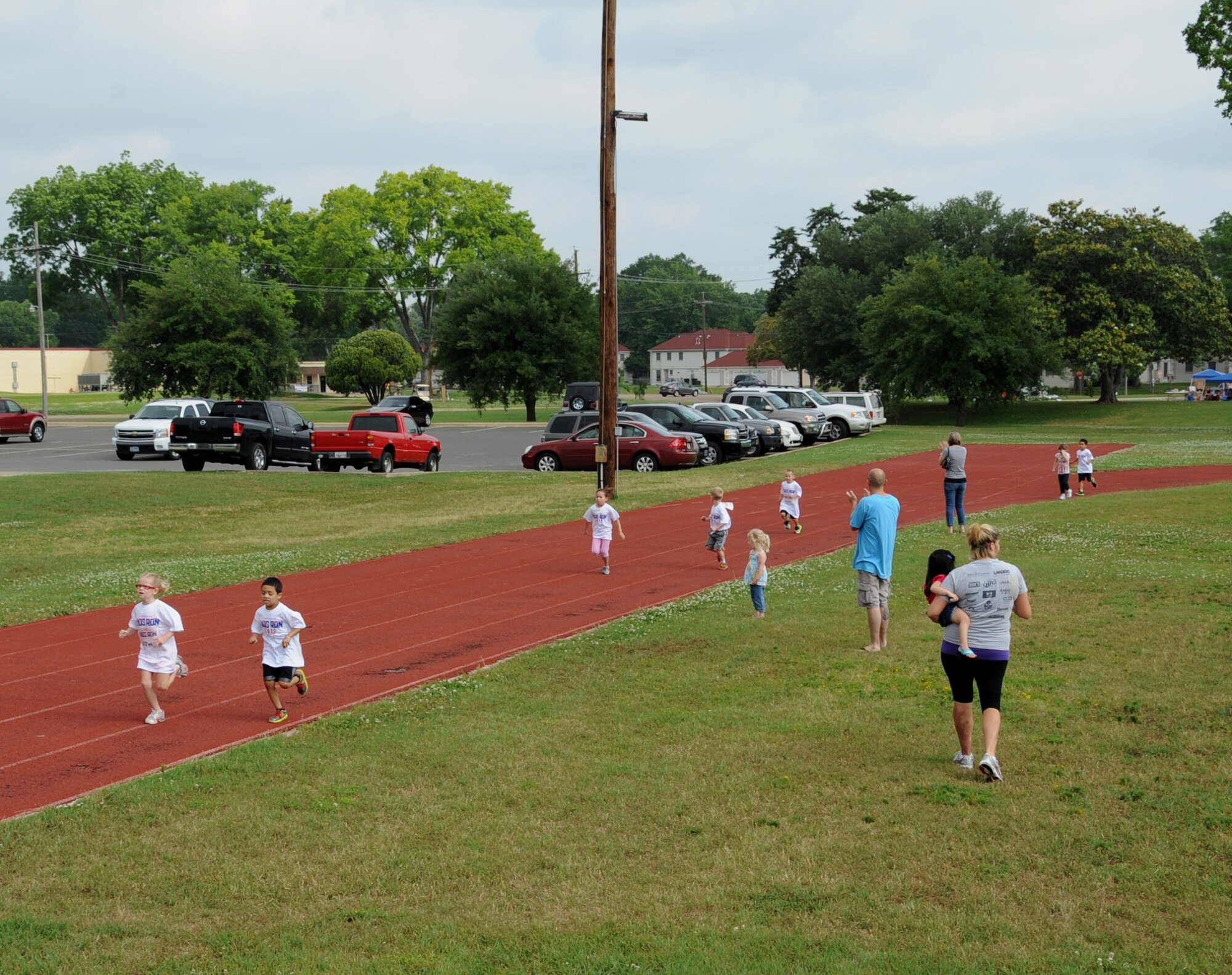 Barksdale children run on the fitness center track during a Kids Run on Barksdale Air Force Base, La., May 18, 2013. More than 40 children participated in the Kids Run. (U.S. Air Force photo/Airman 1st Class Benjamin Gonsier)