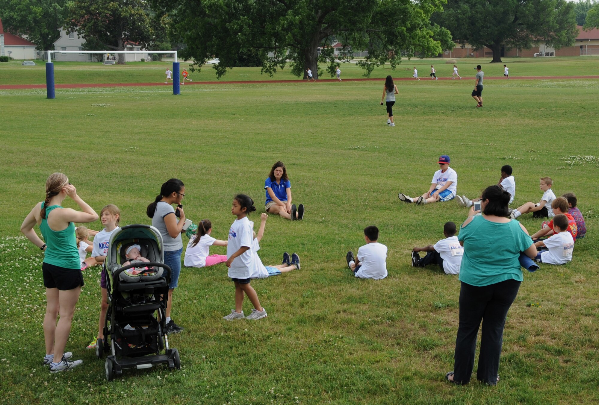 2nd Lt. Katherine Ward, 608th Air Operations Center, leads children in a stretching session during the Kids Run on Barksdale Air Force Base, La., May 18, 2013. The Kids Run featured three different runs, a half-mile run for 5 and 6 year olds, a one-mile run for 7 and 8 year olds and a two-mile run for 9 to 13 year olds. (U.S. Air Force photo/Airman 1st Class Benjamin Gonsier)
