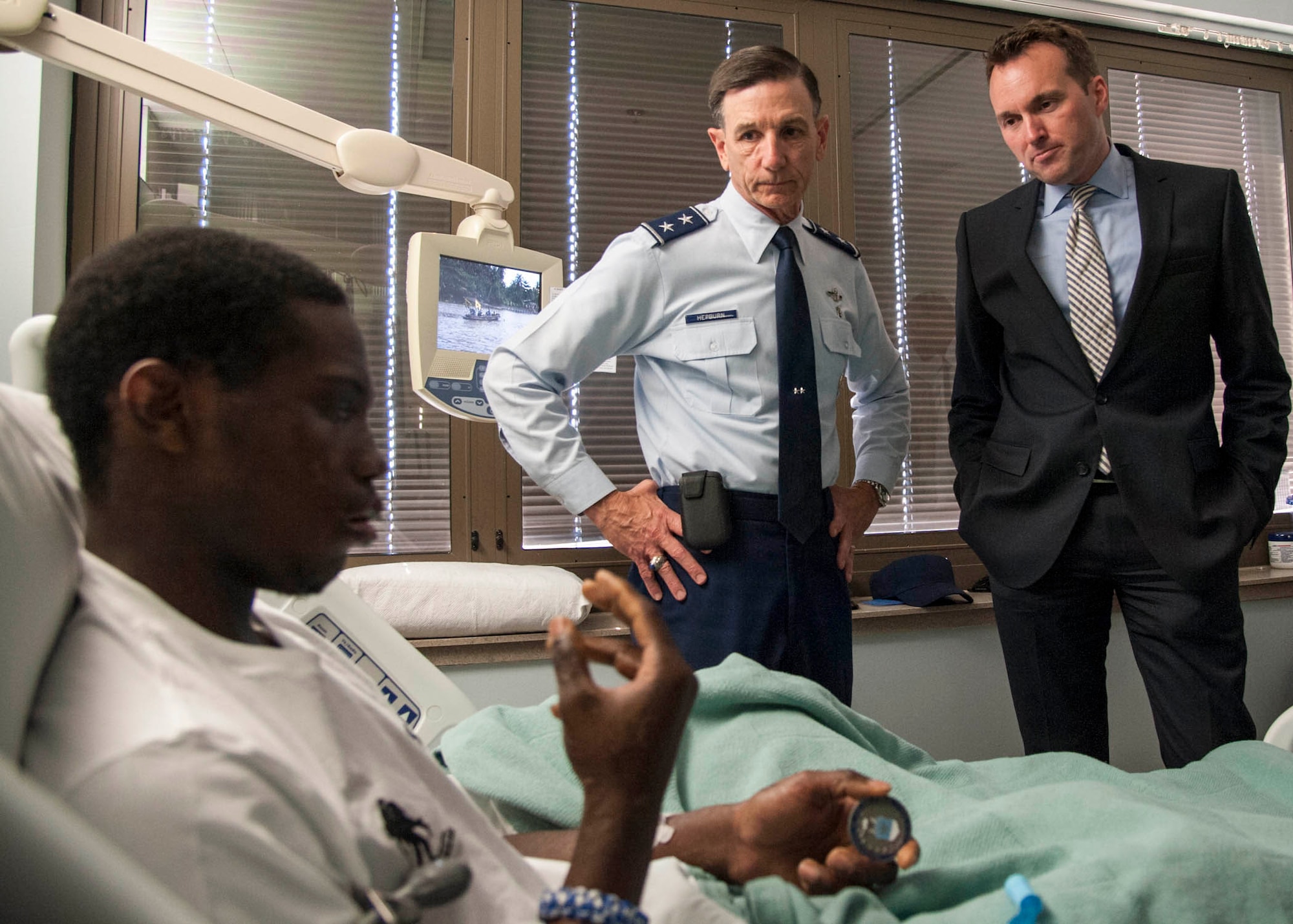 U.S. Air Force Airman 1st Class Jabrier Lee speaks about his condition with Air Force Under Secretary Eric Fanning and U.S. Air Force Maj. Gen. Byron Hepburn, 59th Medical Wing commander and director of the San Antonio Military Health System, at the San Antonio Military Medical Center on Joint Base San Antonio-Fort Sam Houston, Texas, May 16, 2013.  Lee was diagnosed with toxic epidermal necrolysis, a rare skin condition caused by a reaction to drugs, which causes the top layer of skin to detach from the lower layers all over the body. Lee is a maintenance technician assigned to the 19th Aerospace Maintenance Squadron, Little Rock Air Force Base, Ark. Fanning visited with members of JBSA May 16 and 17 with stops at JBSA-Randolph, Lackland, and Fort Sam Houston as part of his first base visit as under secretary.  (U.S. Air Force photo/Staff Sgt. Kevin Iinuma)