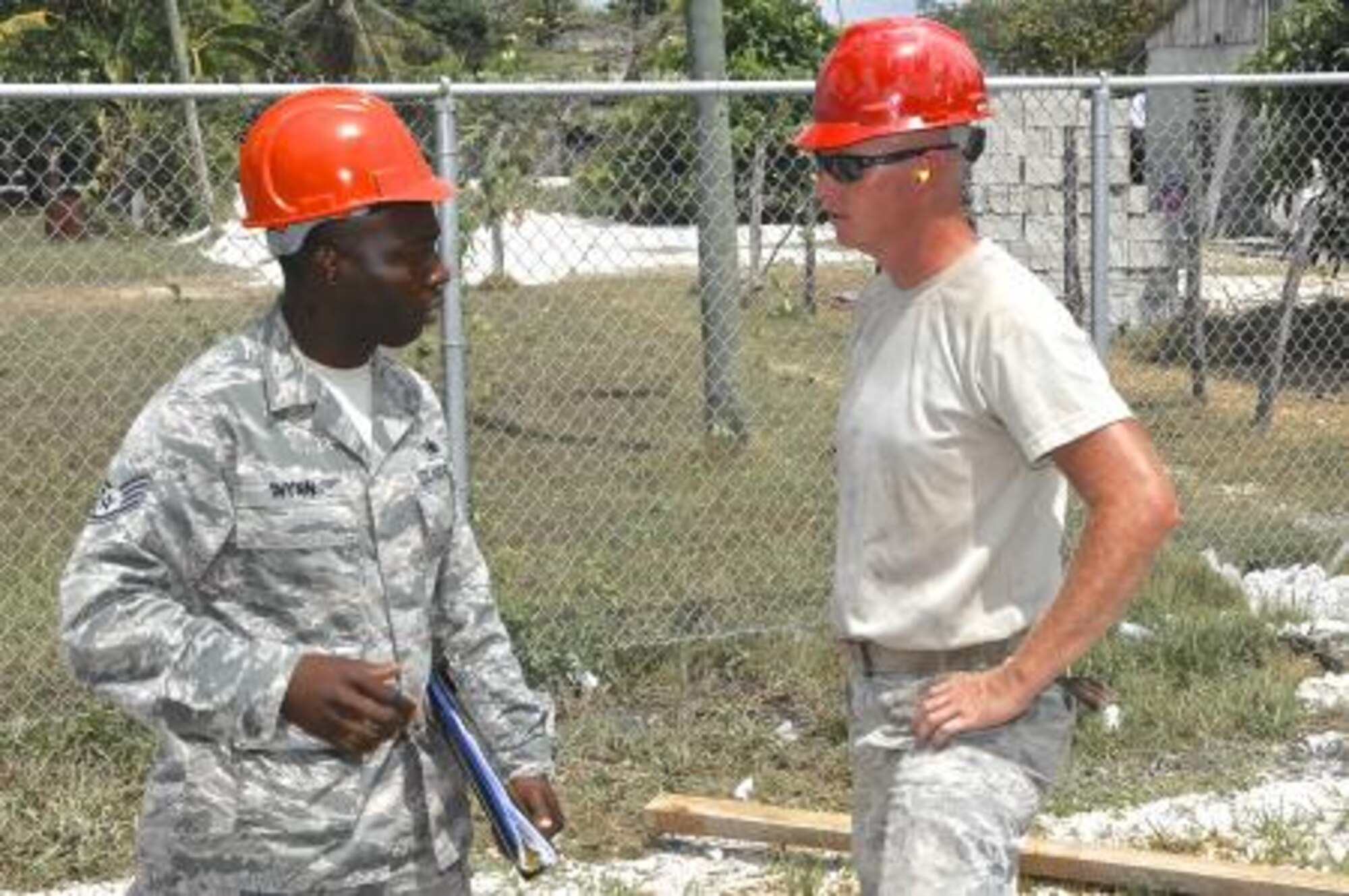 Staff Sgt. Tori Wynn, left, unit safety representative for the 823rd Expeditionary RED HORSE Squadron, talks with Tech. Sgt. Luke McGlone, pavement and equipment supervisor assigned to the 823rd RED HORSE Squadron, at the Trial Farm Government School construction site, May 18, 2013. Wynn was conducting a weekly safety inspection at the site to assist with adherence to safety standards. Civil Engineers from both the U.S. and Belize are constructing various structures at schools throughout Belize as part of an exercise called New Horizons. Building these facilities will support further education for the children of the country and provide valuable training for U.S. and Belizean service members. (U.S. Air Force photo/Master Sgt. James Law)