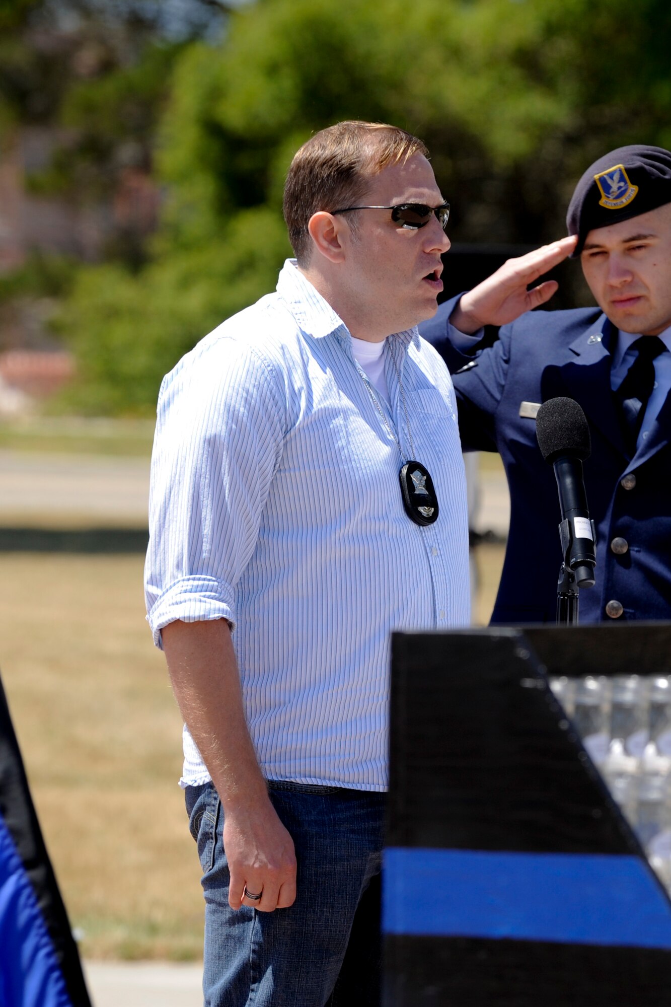 VANDENBERG AIR FORCE BASE, Calif. – Master Sgt. Micah Snyder, 30 Security Forces Squadron intelligence superintendant, sings the nation anthem during a closing ceremony here Friday, May 17, 2013. National Police Week commemorated law enforcement personnel who have fallen in the line of duty. (U.S. Air Force photo/Airman Yvonne Morales)