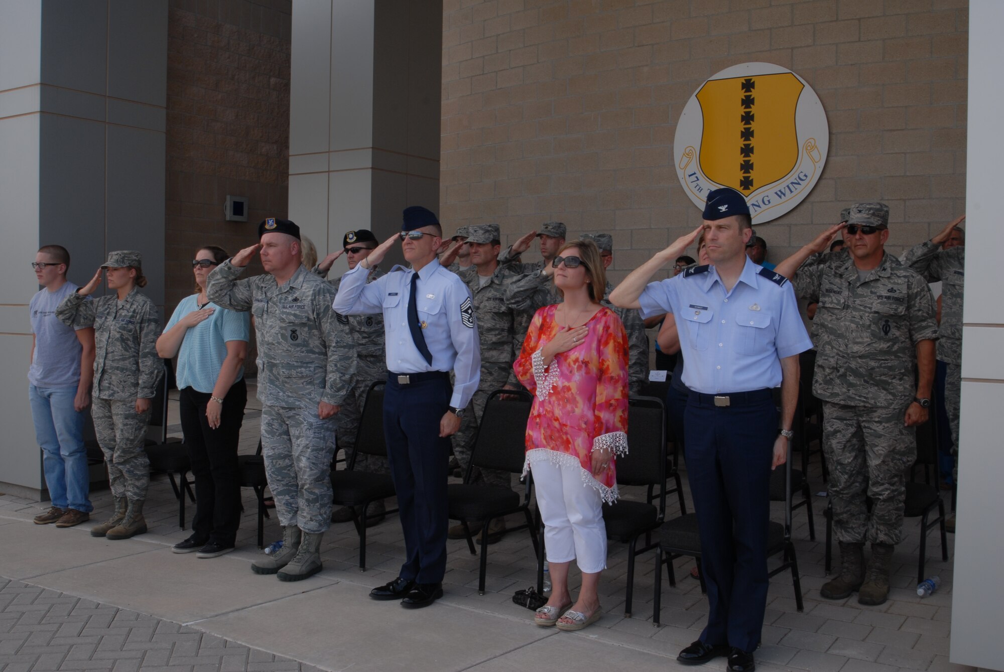 GOODFELLOW AIR FORCE BASE, Texas – Base leadership and their families salute the flag as it is lowered during the retreat ceremony at the Norma Brown building, May 17. Security Forces held different events and activities to commemorate Peace Officers Memorial Day and Police week from May 13 to 17. (U.S. Air Force photo/ Airman 1st Class Breonna Fields) 