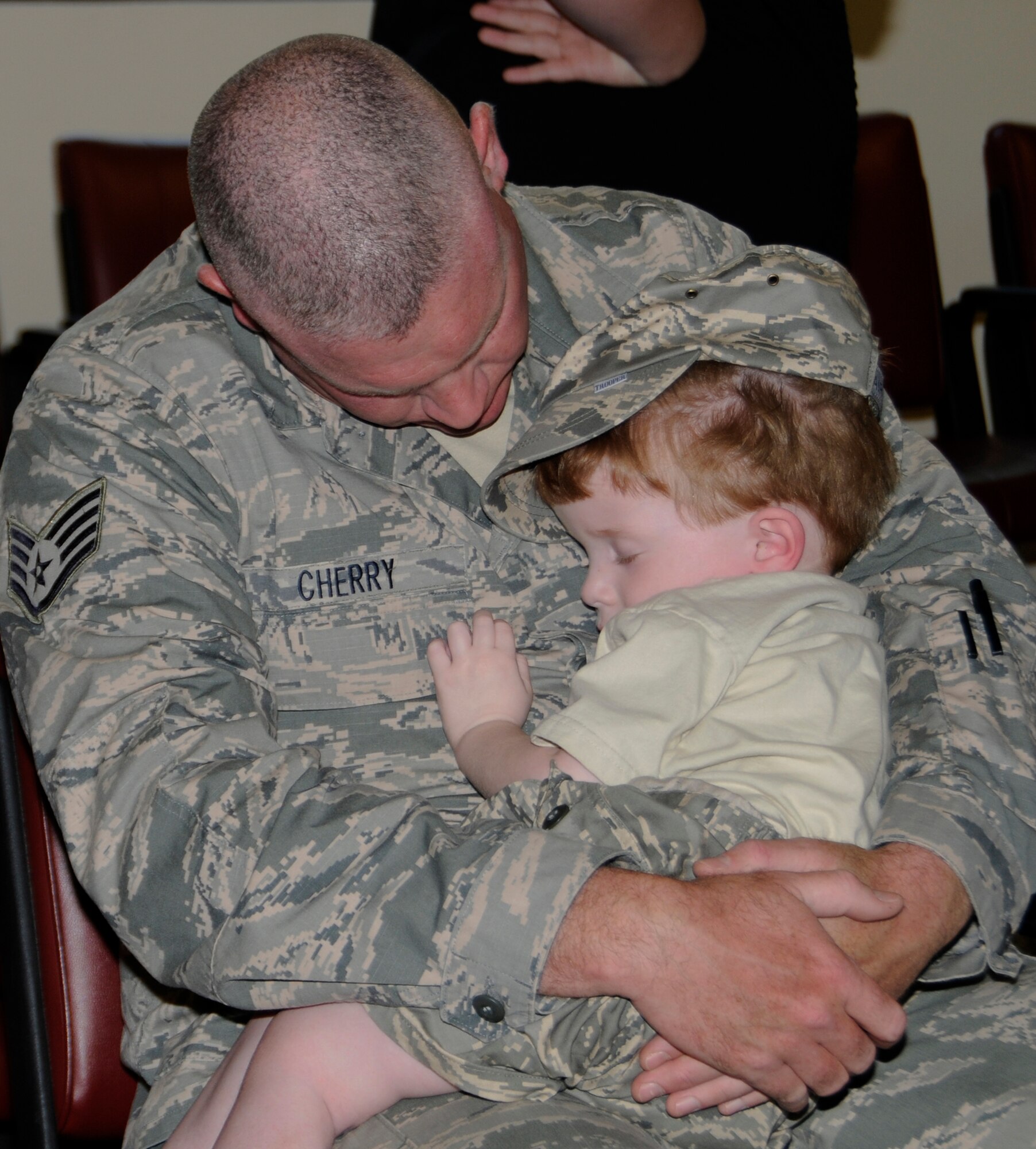 Staff Sgt. Quincy Cherry, a force protection specialist with the 188th Fighter Wing’s Security Forces Squadron, holds his son as he waits to board his flight May 12, 2013. Cherry departed Fort Smith for a six-month deployment to Southwest Asia in support of Operation Enduring Freedom. While there, the 188th SFS will provide installation support and security for assigned aircraft. (U.S. Air National Guard photo by Senior Airman Hannah Landeros/188th Fighter Wing Public Affairs)