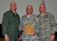 Master Sgt. Randall Bell from the 919th Maintenance Operations Flight displays the award he received as the 919th Special Operations Wing Senior NCO of the Quarter May 5,2013 at Duke Field, Fla.   Shown with him from left are Col. Andy Comtois, the 919th SOW commander, and Chief Master Sgt. Tom Mason, the wing’s command chief.  (U.S. Air Force photo/Tech. Sgt Jasmin Taylor)