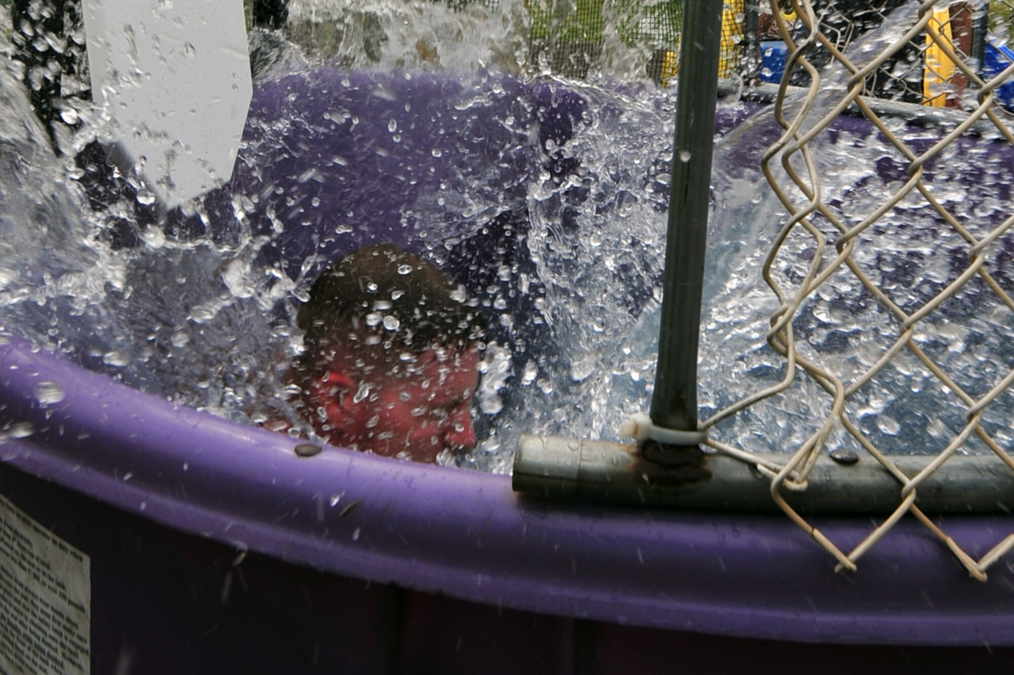 Master Sgt. Aaron Gilbert, 607th Air Support Operations Group first sergeant, gets dunked during a free pig roast hosted by the Osan First Sergeants Council at Osan Air Base, Republic of Korea, May 18, 2013. First sergeants took turns at the dunk tank for the unaccompanied Airmen to take aim. (U.S. Air Force photo/Senior Airman Alexis Siekert) 