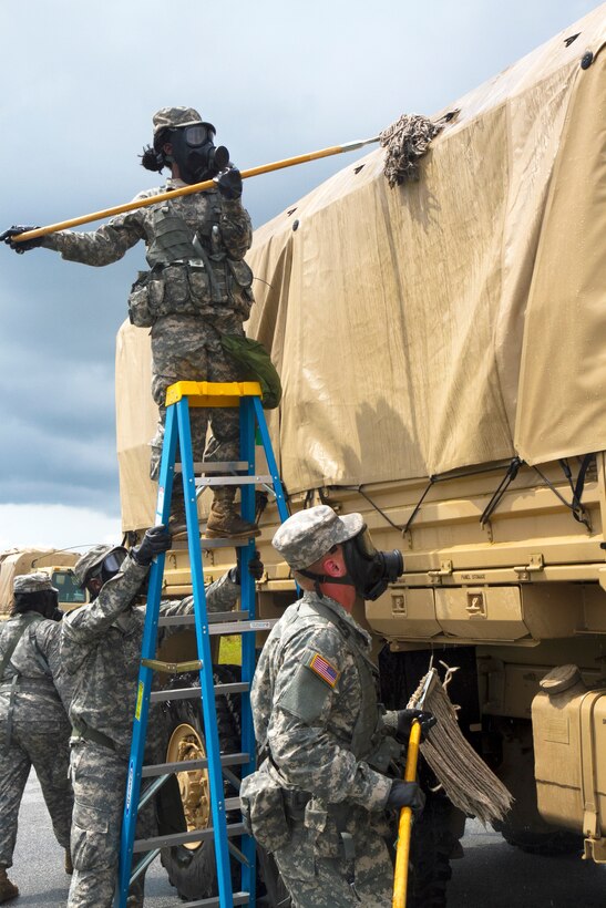U.S. Army soldiers use teamwork to clean trucks as they come through a vehicle decontamination line during an exercise in support of Ardent Sentry, in Varnville, S.C., May 19, 2013. The soldiers are assigned to the 108th Chemical Company, South Carolina Army National Guard.