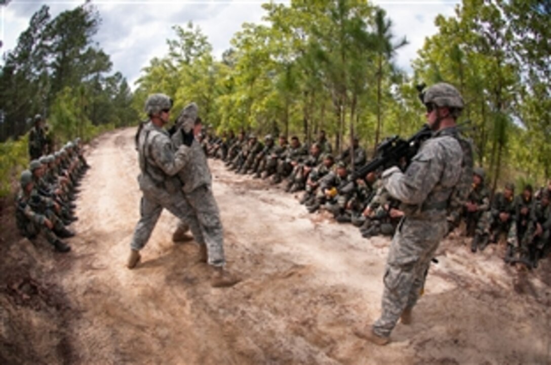 U.S. paratroopers demonstrate their enemy prisoner-of-war handling techniques to Indian soldiers as part of partnered field training during Yudh Abhyas 2013 on Fort Bragg, N.C., May 8, 2013. 
