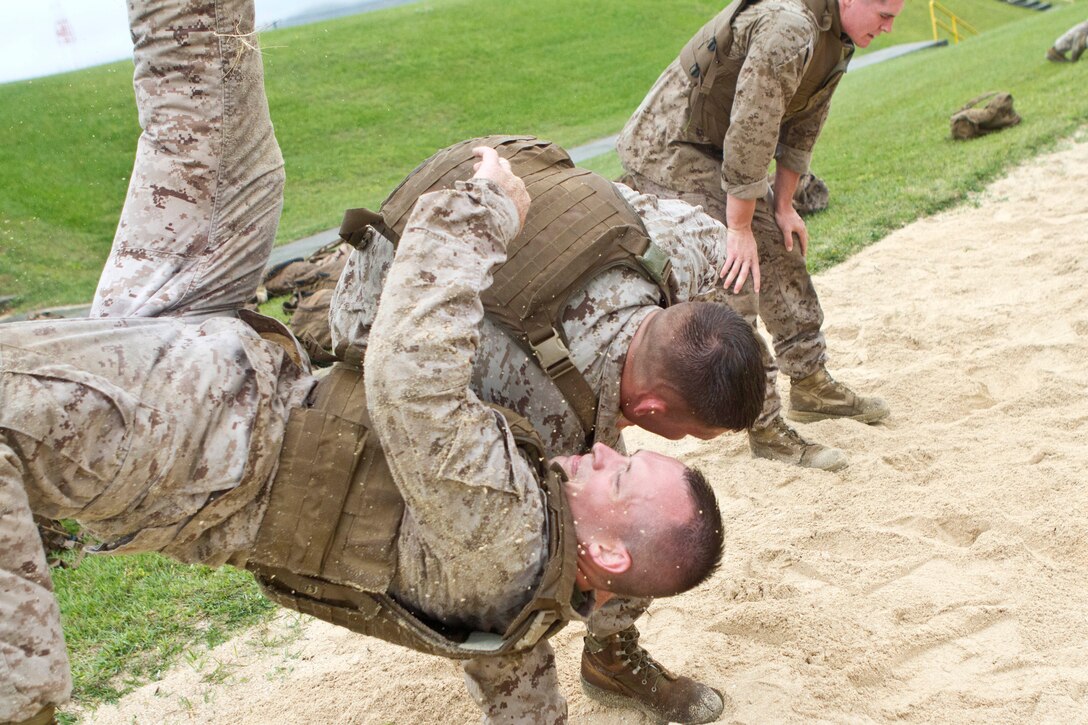 Marines execute shoulder throws as part of the culmination event of the three-week Martial Arts Instructor Course here, May 3 – 17. The students participating in the course learned how to instruct Marines in every aspect of the Marine Corps Martial Arts Program, earning the tan tab sewn on their belts, denoting them as instructors upon completion. The 31st MEU is the only continuously forward-deployed MEU and is the Marine Corps’ force in readiness in the Asia-Pacific region.