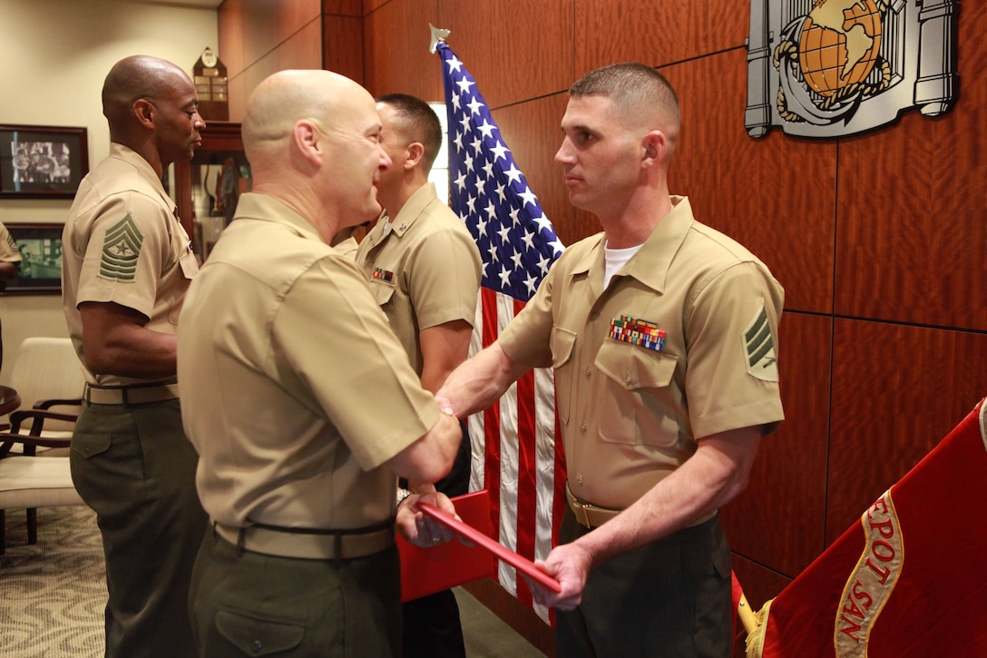 Sgt. Eric P. Mcintosh, the motor transportation chief with the 9th Marine Corps District, is presented a Certificate of Commendation by Col. Robert Gates, chief of staff at Marine Corps Recruit Depot, Western Recruiting Region, at an awards ceremony ending the Western Recruiting Region Noncomissioned Officer of the Quarter board, May 9. Mcintosh was selected as the WRR NCO of the quarter.