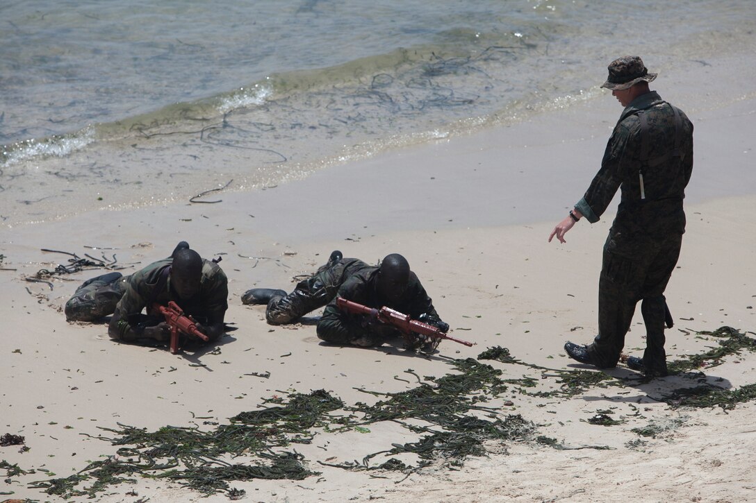 Sgt. Blaec Nelson, Special-Purpose Marine Air — Ground Task Force Africa 13 reconnaissance Marine from Kailua, Hawaii, instructs Senegalese Companie de Fusilier Marine Commandos scout swimmer fundamentals at Bel-Air military base in Dakar, Senegal, April 19, 2013. Marines and Sailors with Special-Purpose MAGTF Africa 13 were recently in Senegal working with Companie de Fusilier Marine Commandos on combat marksmanship, maritime security and light infantry operations. Special-Purpose MAGTF Africa strengthens U.S. Marine Corps Forces Africa and U.S. Africa Command's ability to assist partner nations. The approximately 150 U.S. Marines and Sailors conduct security force assistance, military-to-military engagements and are trained to provide support to crisis response. (U.S. Marine Corps photo by Cpl. Timothy Norris/Released)

