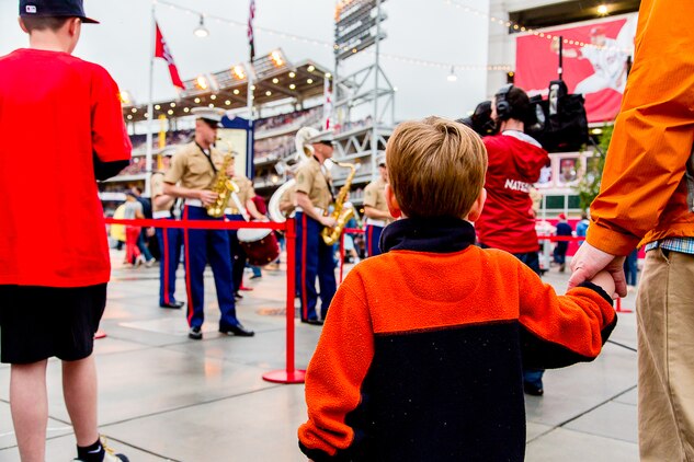 The crowd looks on as the Quantico Marine Corps Band's Party Band plays during the May 5th, 2013, Marine Day baseball game. The Party Band performed three songs just inside park prior to the game.  