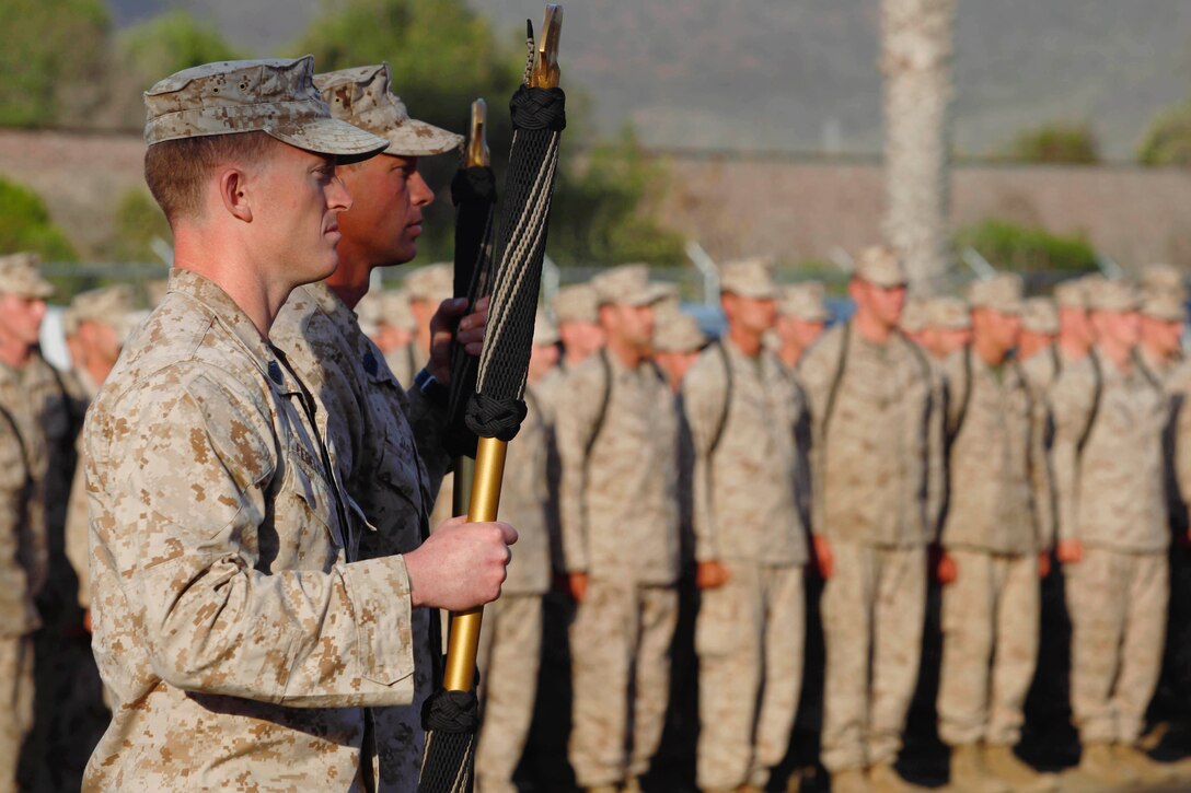 Gunnery Sgt. Tyler Fedelchak and teammate Master Sgt. David Jarvis stand at attention while Basic Reconnaissance Course students recite the Recon Creed during the 5th Annual Recon Challenge award ceremony here May 17.  Fedelchak and Jarvis won first place with a time of 8 hours and 36 minutes. 
