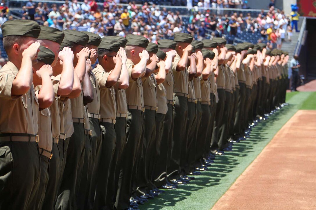 Marines with the 15th Marine Expeditionary Unit salute during the playing of the national anthem at the Padres' Military Appreciation Day at PETCO Park in San Diego, May 19. The 15th MEU was invited to the game to celebrate their return from an eight-month deployment. During the event, Marines from each supporting element of the MEU stepped onto the field in front of thousands as the 15th MEU Command Element, Battalion Landing Team 3/5, Combat Logistics Battalion 15 and Marine Medium Helicopter Squadron 364 (Rein.) were recognized. (U.S. Marine Corps photo by Cpl. Timothy Childers/Released)