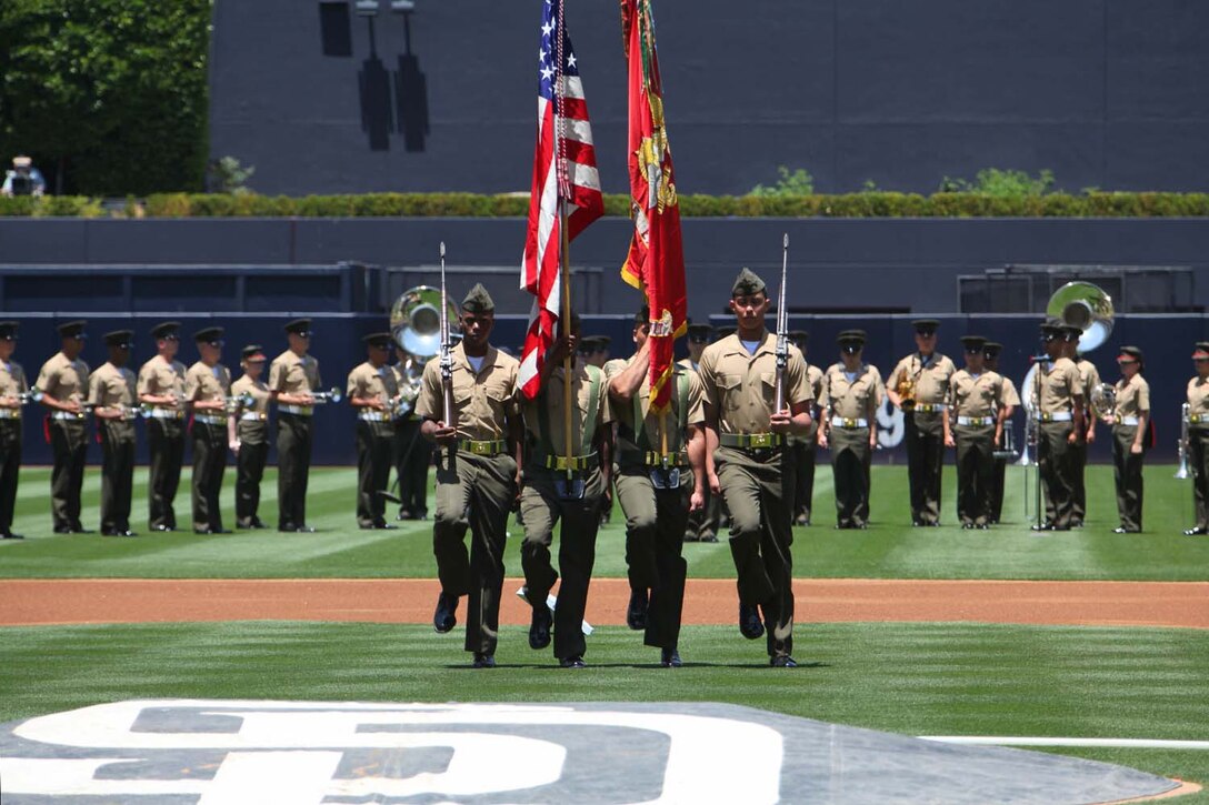 The 15th Marine Expeditionary Unit color guard march on the PETCO Park field during the Padres' Military Appreciation Day at PETCO Park in San Diego, May 19. Marines with the 15th MEU were invited to the game to celebrate their return from an eight-month deployment. During the event, Marines from each supporting element of the MEU stepped onto the field in front of thousands as the 15th MEU Command Element, Battalion Landing Team 3/5, Combat Logistics Battalion 15 and Marine Medium Helicopter Squadron 364 (Rein.) were recognized. (U.S. Marine Corps photo by Cpl. Timothy Childers/Released)