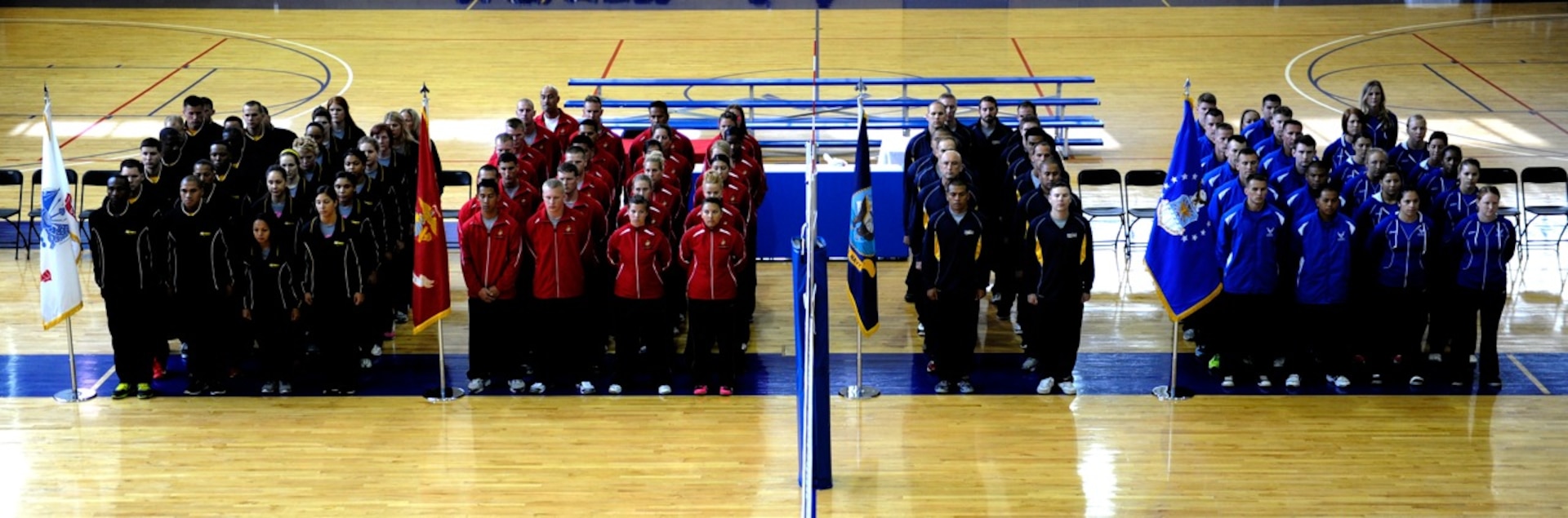 Teams from across the Services line up for the opening ceremony of the 2013 Armed Forces Indoor Volleyball Championship at Hill AFB, UT.  Army men and women took home team titles in the 2013 competition, just one week after taking both beach volleyball golds.