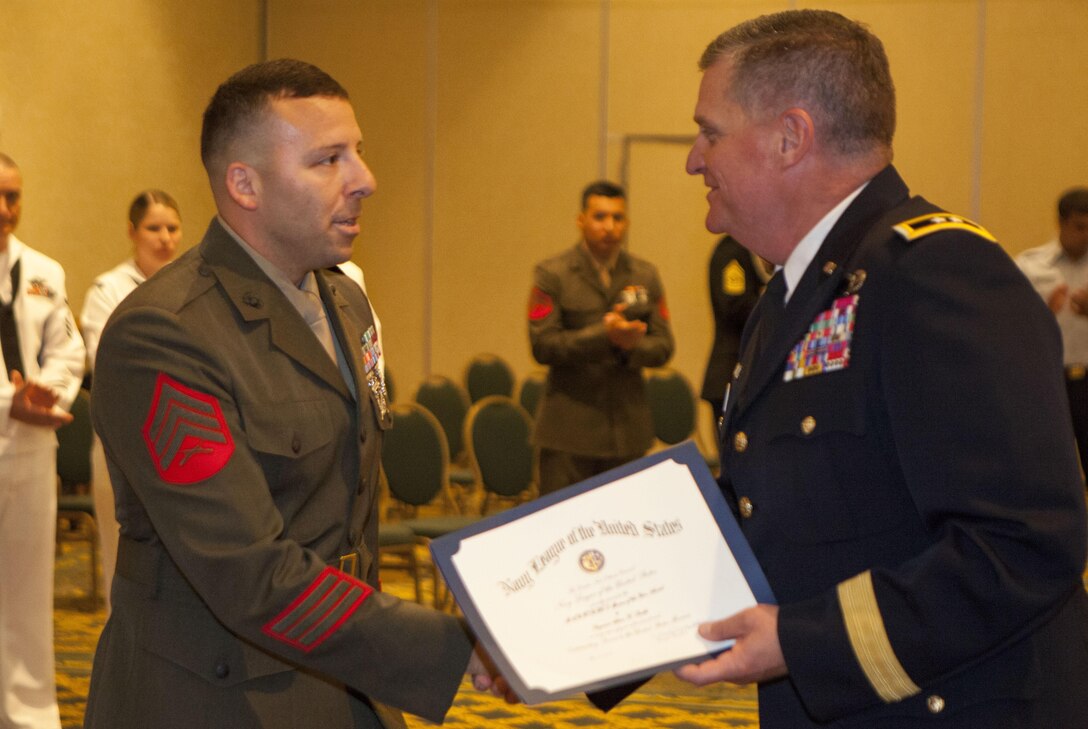 Sgt. Adam K. Smith, the repairable issue point chief for Marine Forces Reserve logistics and services, is presented a Navy League distinguishing award by Army Maj. Gen. Glenn H. Curtis, the adjutant general of the Louisiana National Guard, at the 2013 Armed Forced Day Luncheon here, May 21. Smith, along with service members from all branches, attended the annual luncheon that celebrated Louisiana’s armed forces personnel. Smith was awarded  because he was named the MARFORRES 2012 Marine of the Year (active component). 