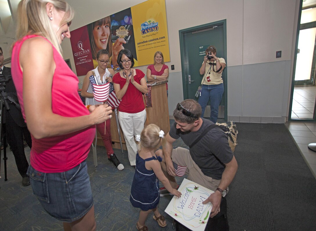 Captain Derek Mills, a pilot with Marine Attack Squadron 513 aboard Marine Corps Air Station Yuma, Ariz., is welcomed home by his wife and their daughter after a 6-month deployment with the 31st Marine Expeditionary Unit. The Marines from VMA-513, who returned home to MCAS Yuma, May 18, were operating in Japan and aboard the USS Bonhomme Richard in the North Pacific Ocean since December of last year.  This marks the final adventure for the VMA-513 Flying Nightmares, as the Squadron is slated for decommissioning this summer.