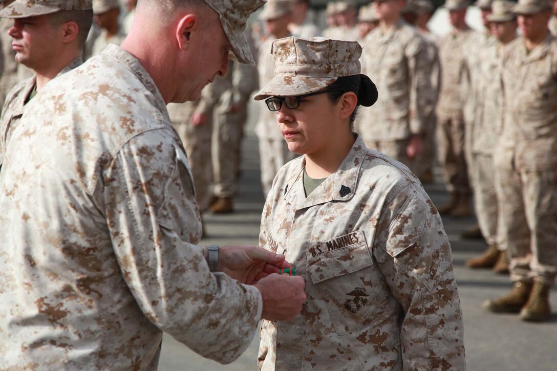 Sergeant Crystal M. Estrada, food service specialist, Command Element, 15th Marine Expeditionary Unit, is awarded the Navy and Marine Corps Achievement Medal at Camp Pendleton, Calif., May 15. Estrada was awarded the medal for her service during the MEU's Western Pacific Deployment.  Estrada, 23, is from San Antonio. (U.S. Marine Corps photo by Cpl. Timothy Childers/Released)