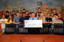 Jacob J. Schaffer, accompanied by his Belle Plaine High School economics class, accepts an NROTC Scholarship from Recruiting Station Twin Cities May 21. Schaffer, who enlisted in the Delayed Entry Program in October, will attend Kansas University later this year. He was recruited by Recruiting Substation Burnsville's Sgt. Timothy J. Klimek, a 32-year-old South St. Paul, Minn., native. For additional imagery from the event, visit www.facebook.com/rstwincities.