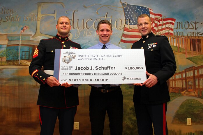 Recruiting Station Twin Cities' Sgt. Timothy J. Klimek and Executive Officer Capt. Timothy R. O'Neil present Belle Plaine High School's Jacob J. Schaffer with an NROTC Scholarship May 21. Schaffer, who initially enlisted out of the Burnsville, Minn., office in October, will attend Kansas University later this year. He was one of only seven individuals in a 100,000 square-mile radius who received an NROTC scholarship from RS Twin Cities. For additional imagery from the event, visit www.facebook.com/rstwincities.