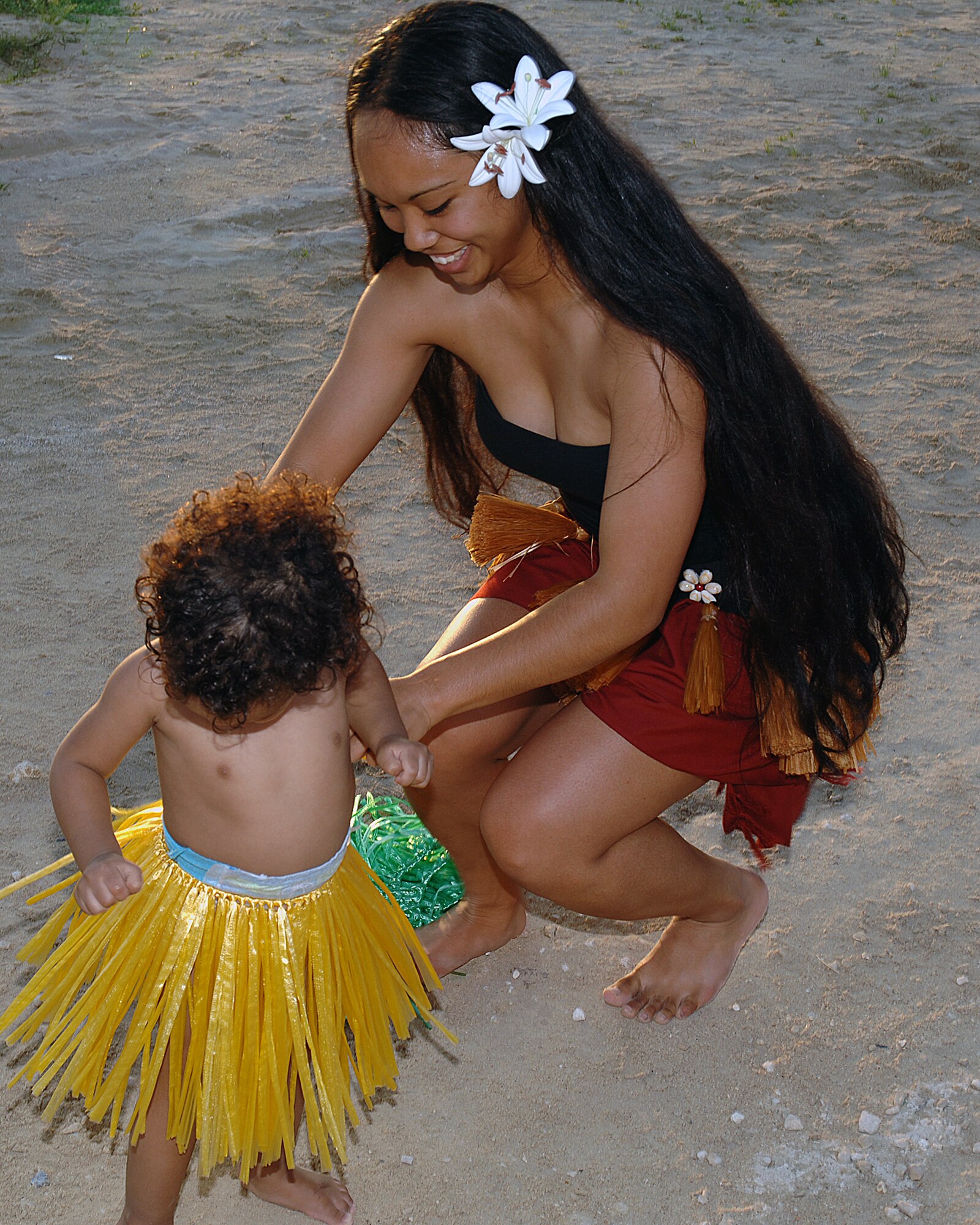 Shae Wilson, daughter of Sheillani Wilson, gets ready to perform with the hula dancers during the Deployed Spouses Luau on Torii Beach, Japan, May 18, 2013. The luau offered families of deployed service members the opportunity to dine and socialize while enjoying the Torii Beach Water Park, children’s activities, a hula show and more. (U.S. Army photo by Ichiro Tokashiki/Released) 
