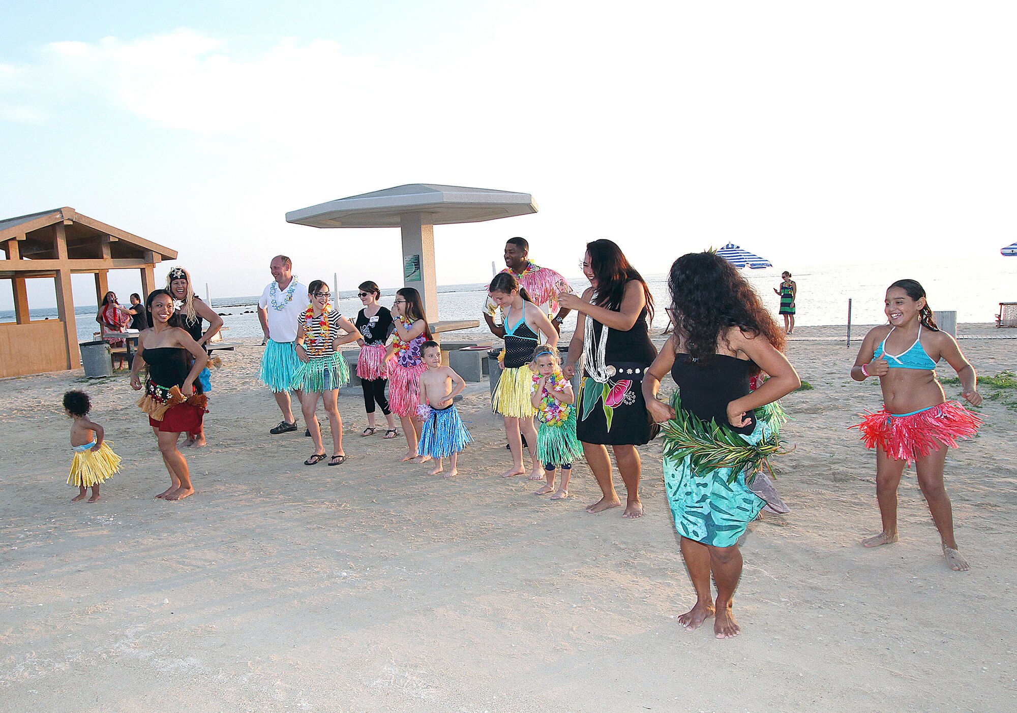 Members of the audience take part in hula dancing provided by Okinawa's Hui Nohona Aloha dance group during the Deployed Spouses Luau on Torii Beach, Japan, May 18, 2013. The luau was open to all branches of the military and was hosted by Army Community Service on Torii Station and the Airman and Family Readiness Center on Kadena Air Base. (U.S. Army photo by Ichiro Tokashiki/Released) 
