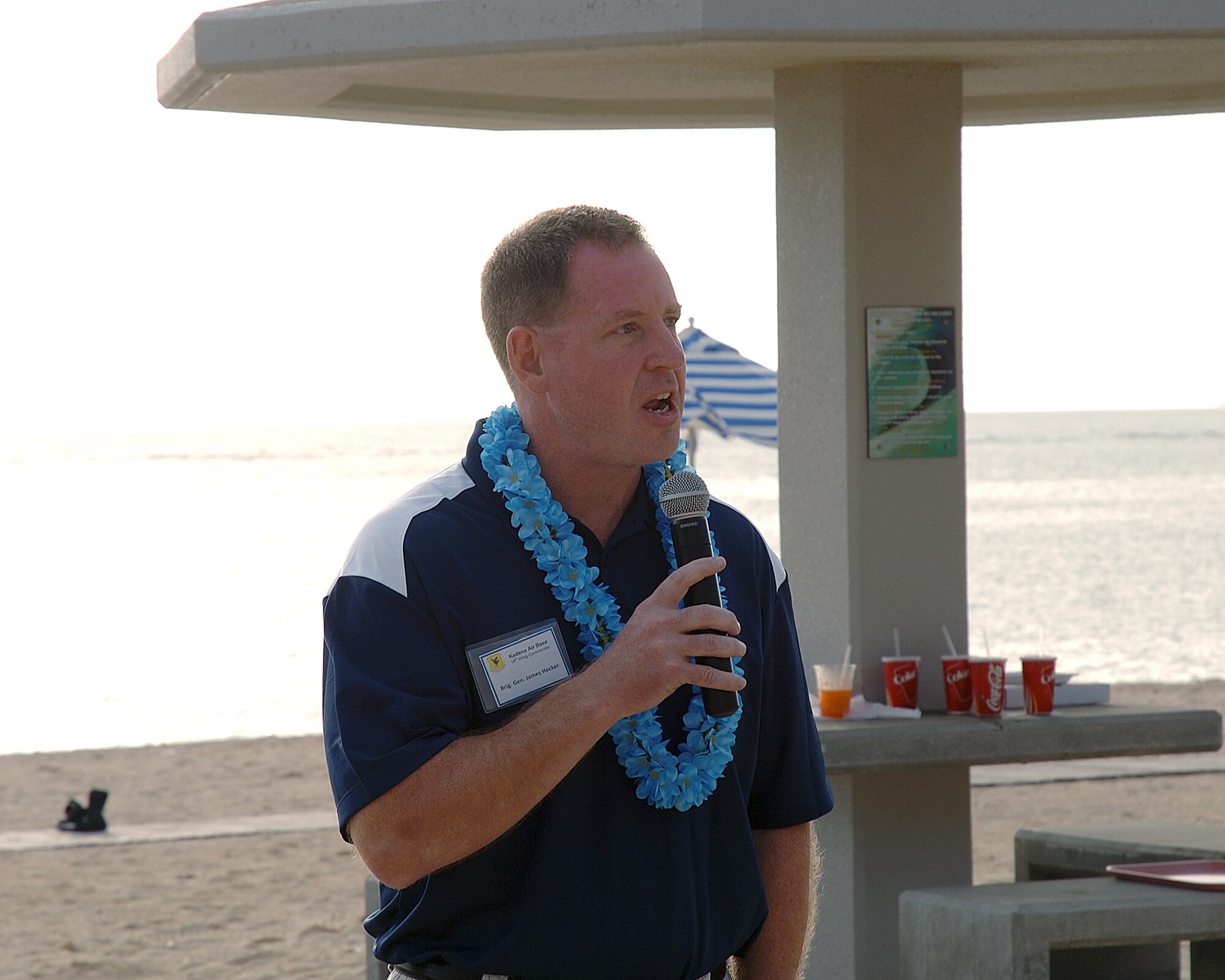U.S. Air Force Brig. Gen. James Hecker, 18th Wing commander, addresses participants of the Deployed Spouses Luau on Torii Beach, Japan, May 18, 2013. More than 225 people attended the luau, including 37 spouses of deployed service members from the Army and Air Force. (U.S. Army photo by Ichiro Tokashiki/Released) 
