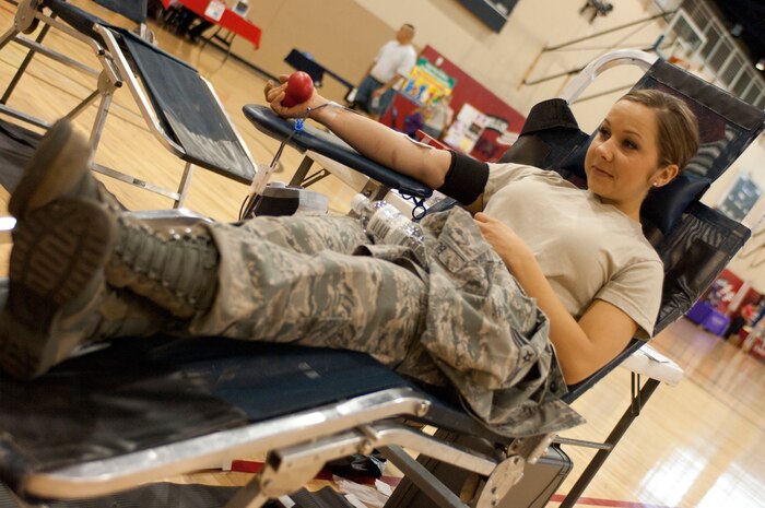Airman 1st Class Ashley Blaire, 99th Aerospace Medical Squadron public health technician, squeezes a stress ball while donating blood May 17 at the Warrior Fitness Center at Nellis Air Force Base, Nev. More than 40 people took time out of their day to donate blood. (U.S. Air Force photo by Airman 1st Class Joshua Kleinholz)