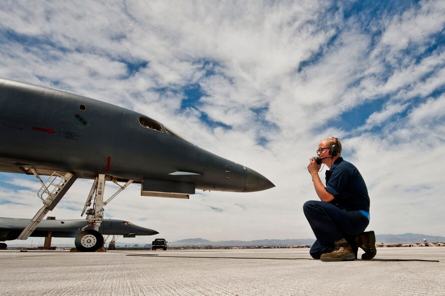 Senior Airman Matthew Crow talks with pilots in a B-1B Lancer during pre-flight communications before taking part in a Green Flag exercise May 21, 2013, at Nellis Air Force Base, Nev. (U.S. Air Force photo/Senior Airman Daniel Hughes) 
